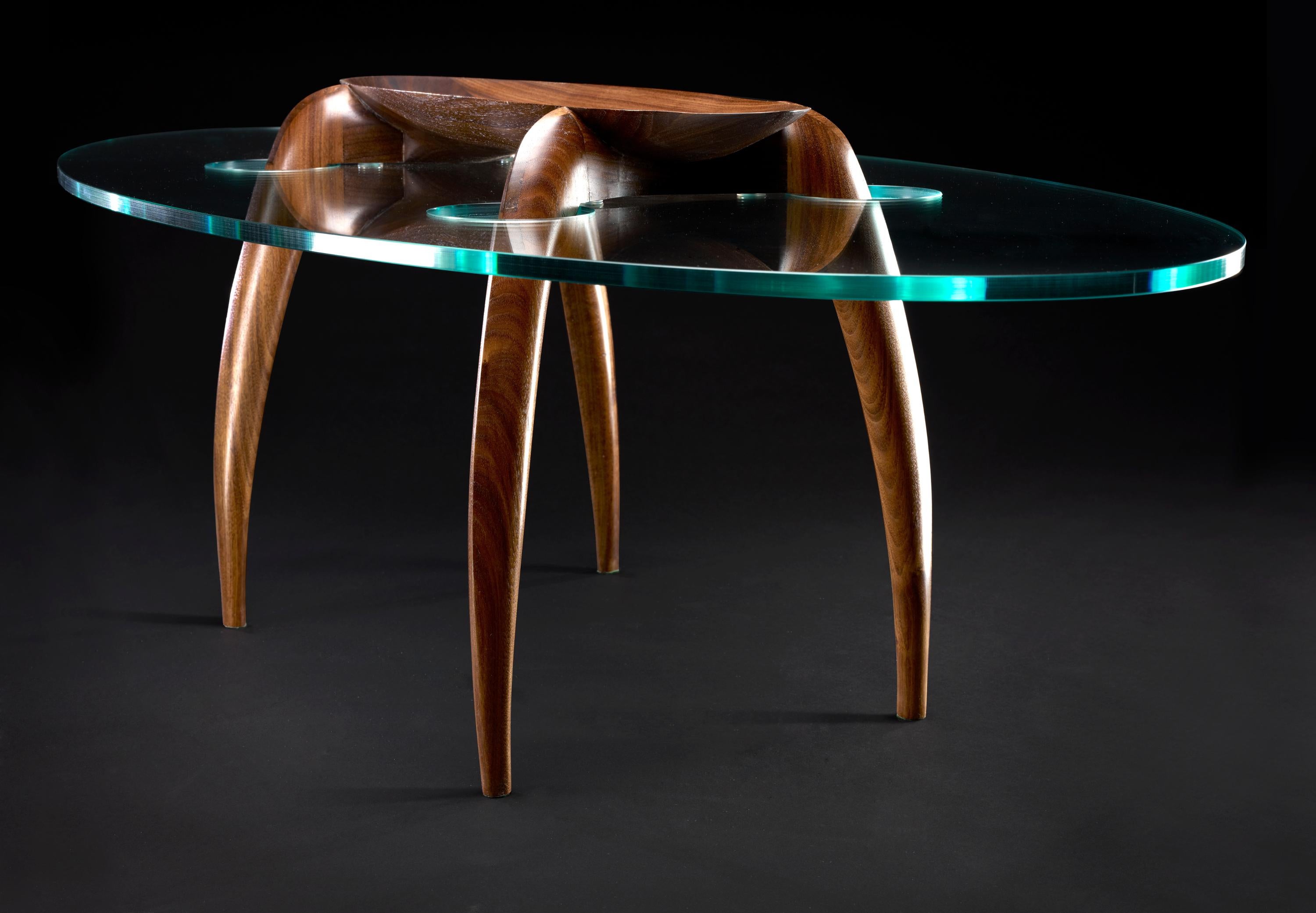 Pragmatism - Walnut Coffee Table Signed by Gildas Berthelot
Title: Vive le Pragmatisme
Material: Black Walnut, Glass
Dimensions: 49'' (L) 19'' (W) 13'' (H)
Signed by Gildas Berthelot

Gildas Berthelot has forged for more than 30 years a