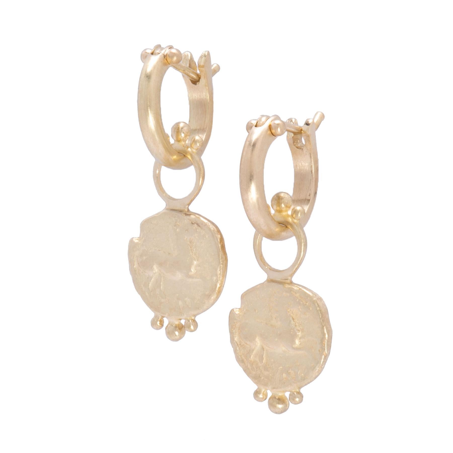Prancing Horse Drops crafted in 18k gold with a satiny finish are cast replicas of the Greek Thrace Maroneian horse coin. The sculptural bas-relief of a cantering horse is set on a textured background on the face of these earrings. A crown of gold