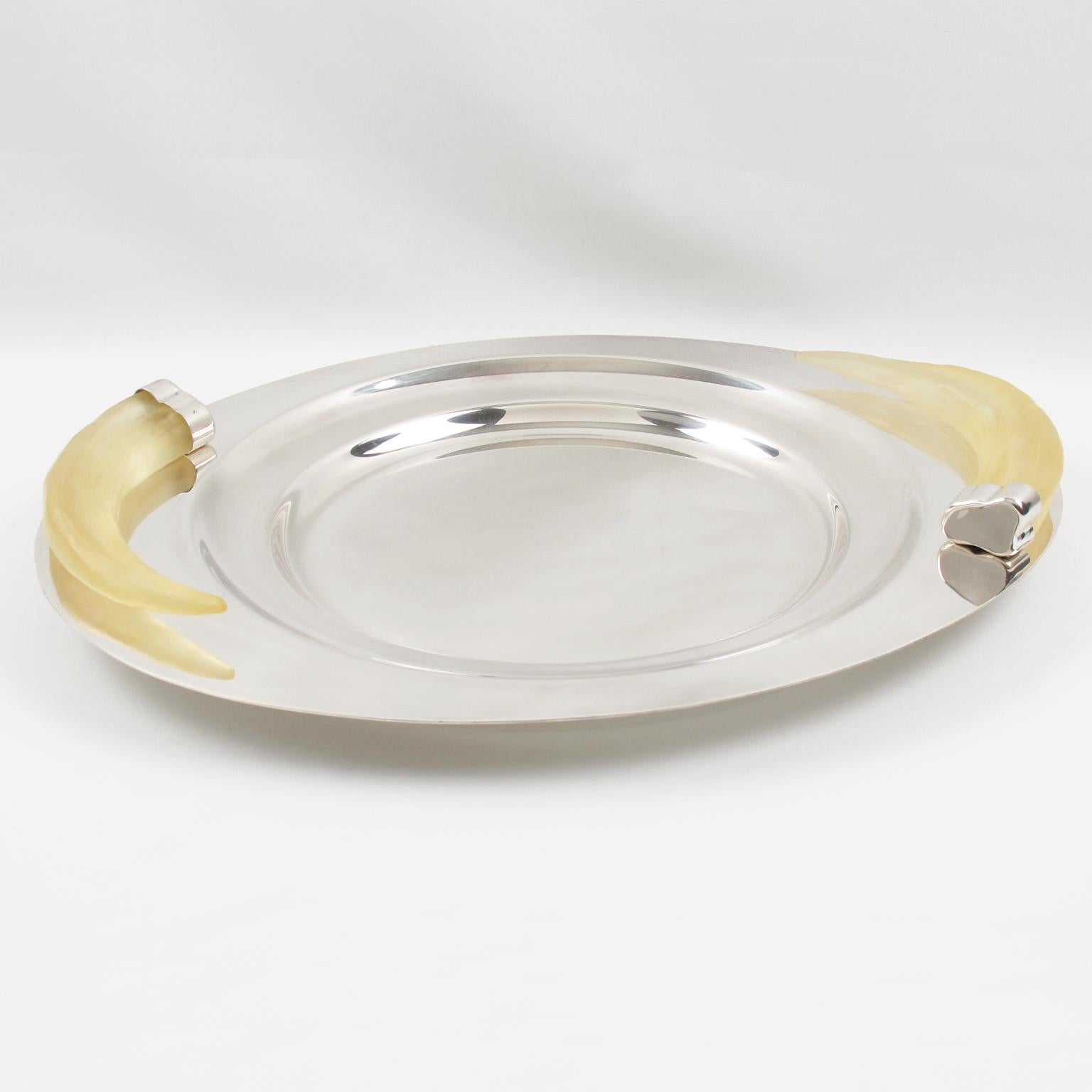 SIlversmith Prata Wolff designed this stunning large serving tray or centerpiece in the 1980s. The heavy silver plate platter is ornate with frosted Lucite carved horn-shaped handles. This superb modernist design was created by this German-origin
