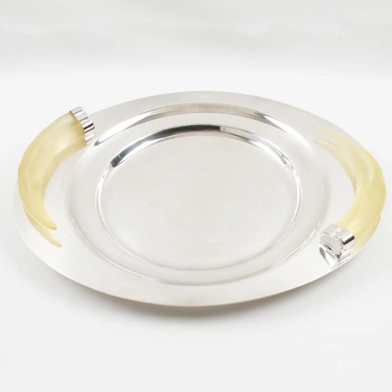 Stunning large serving tray or centerpiece designed by Prata Wolff, Brazil. Heavy silver plate platter ornate with frosted Lucite carved horn-shaped handles. A superb modernist design was created by this German-origin company located in Brazil.
The