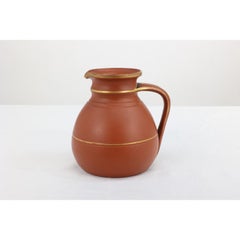 Prattware. A Gothic Revival terracotta jug with gilded line decoration.