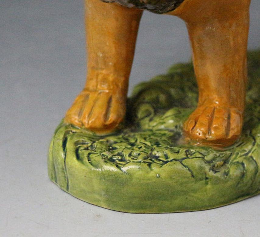 Prattware Pottery Figure of a Lion on a Grass Base, 19th Century In Good Condition For Sale In Woodstock, OXFORDSHIRE
