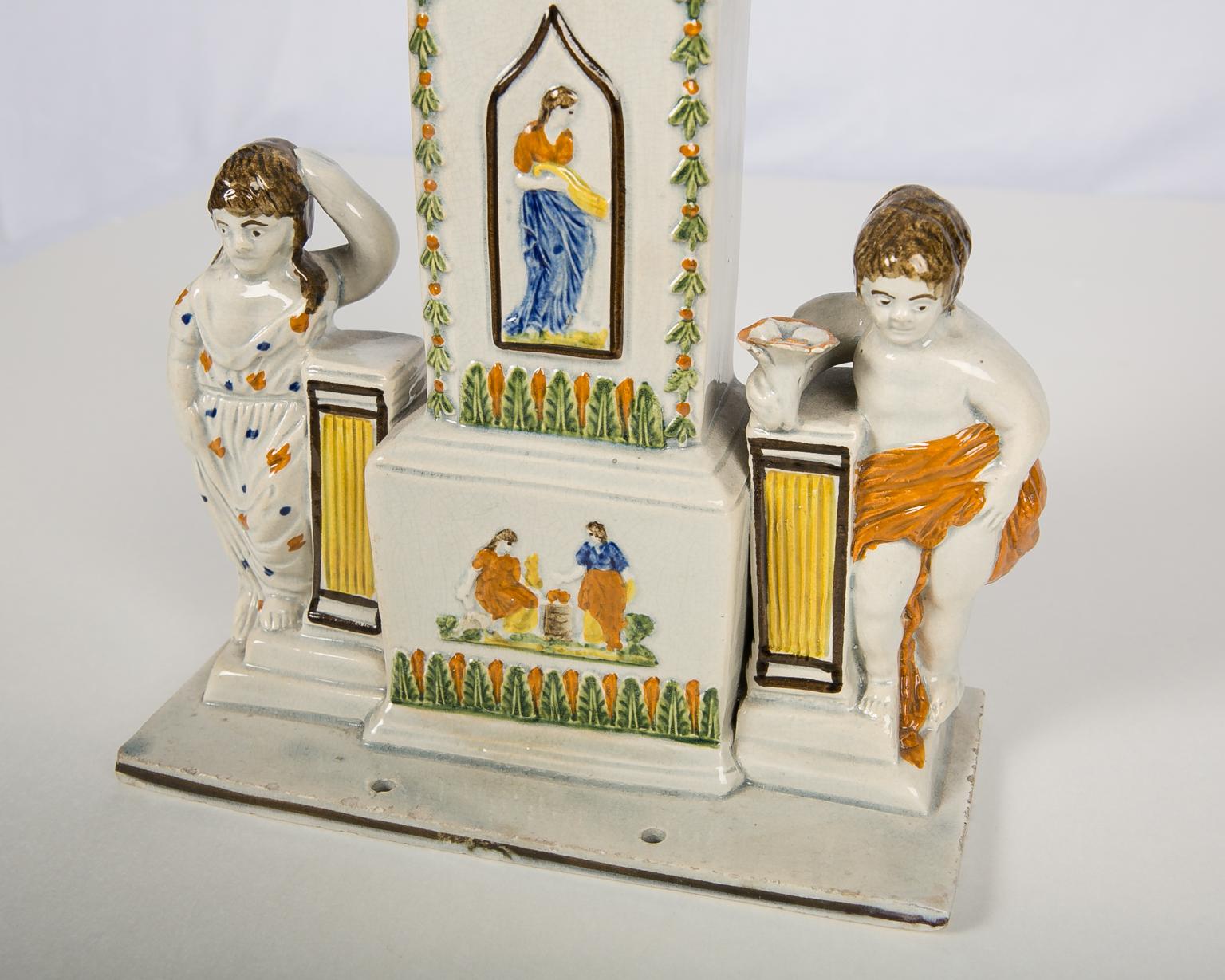  This Prattware watch stand has its original pottery watch.
 In our 57 years in business, this is the only watch stand we have ever seen complete with its original watch. So, this is a rare piece! It was made by 