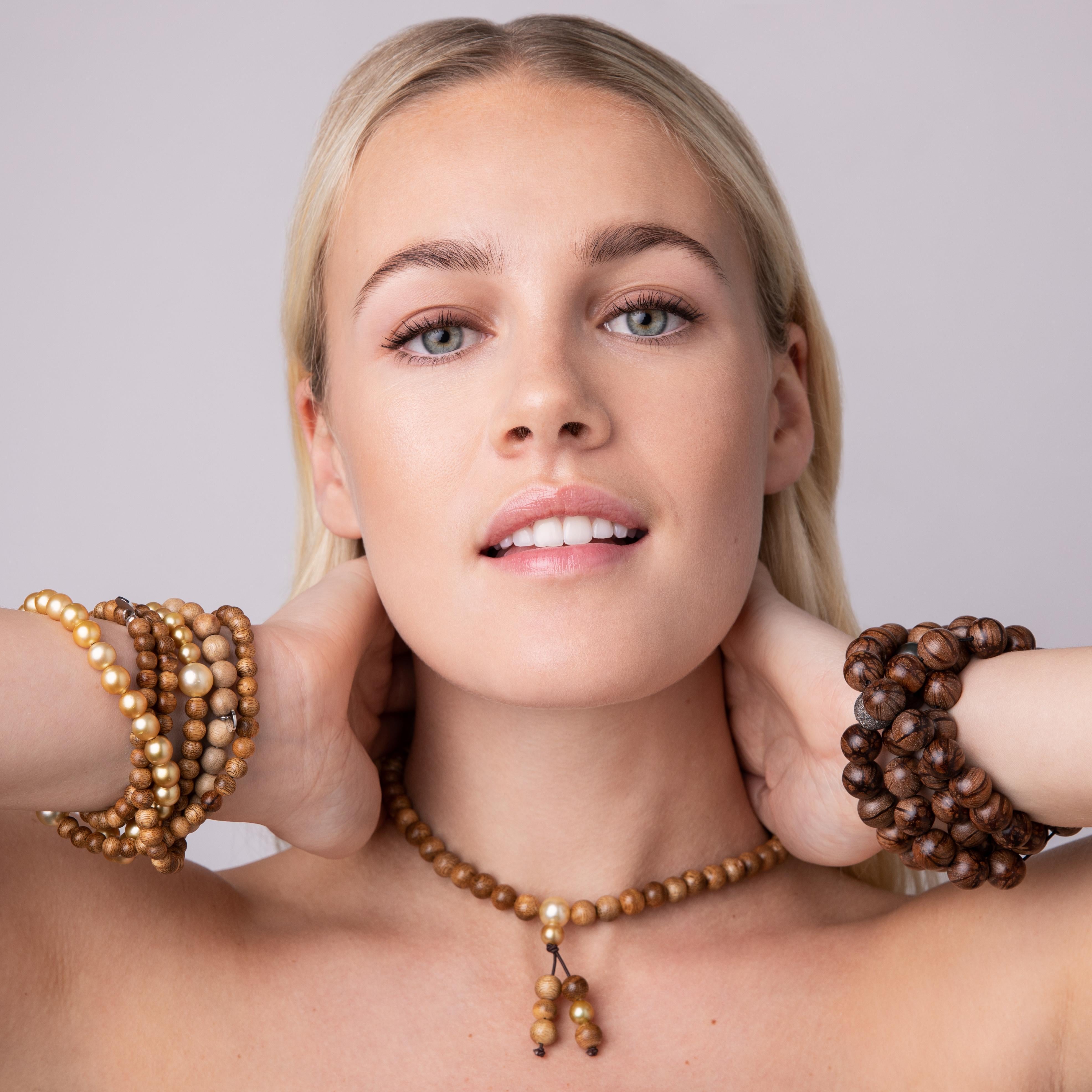 This jewelry piece is inspired by the Buddhist prayer necklaces. It can be worn as a shorter necklace or wrapped around the wrist. It is captivating with its intriguing golden pearls. Its elegance and casualness are amazing and it can be worn with