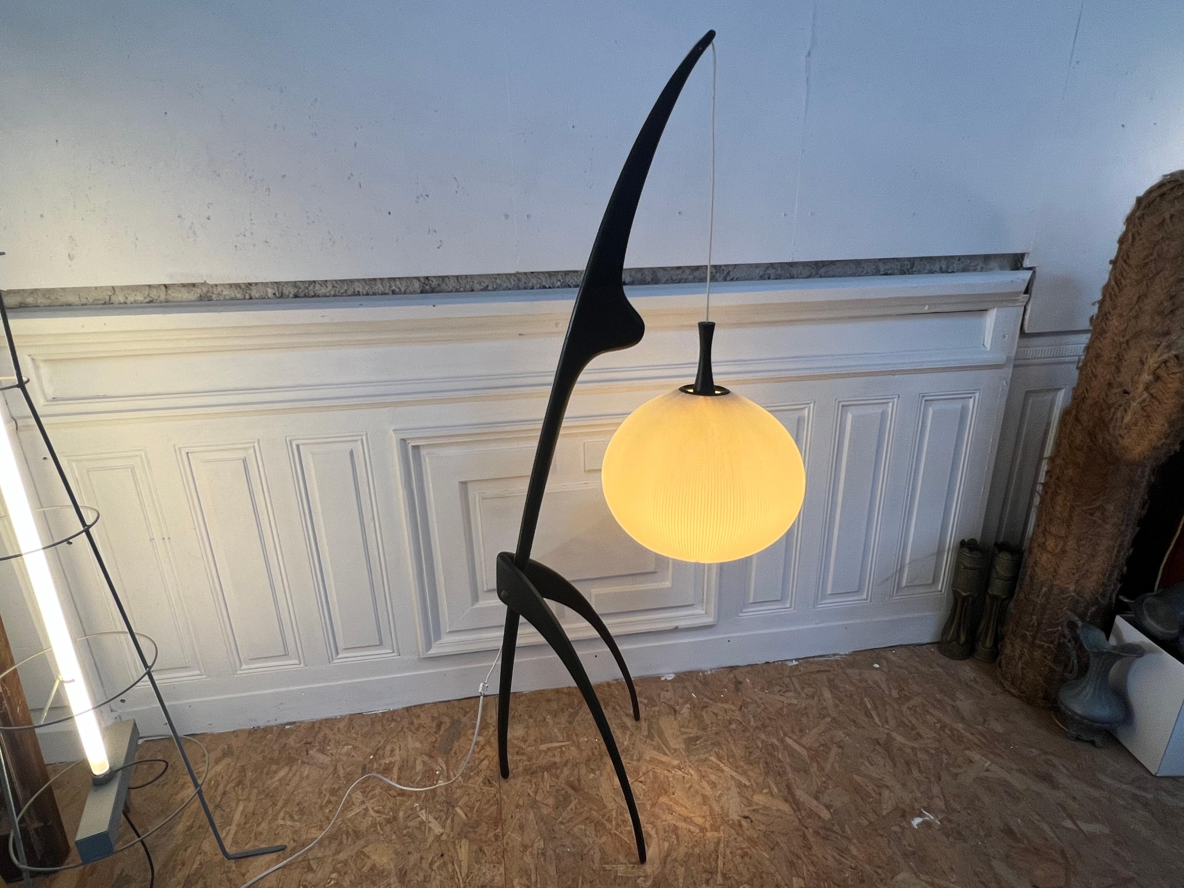 Iconic floor lamp 1950’s by Jean Rispal with a dark strained wooden frame and praying manta legs and suspended spherical shade fabricated from ribbed parchment paper

The Rispal house was founded in 1924 by Georges Léon Rispal at 172 Rue de Charonne