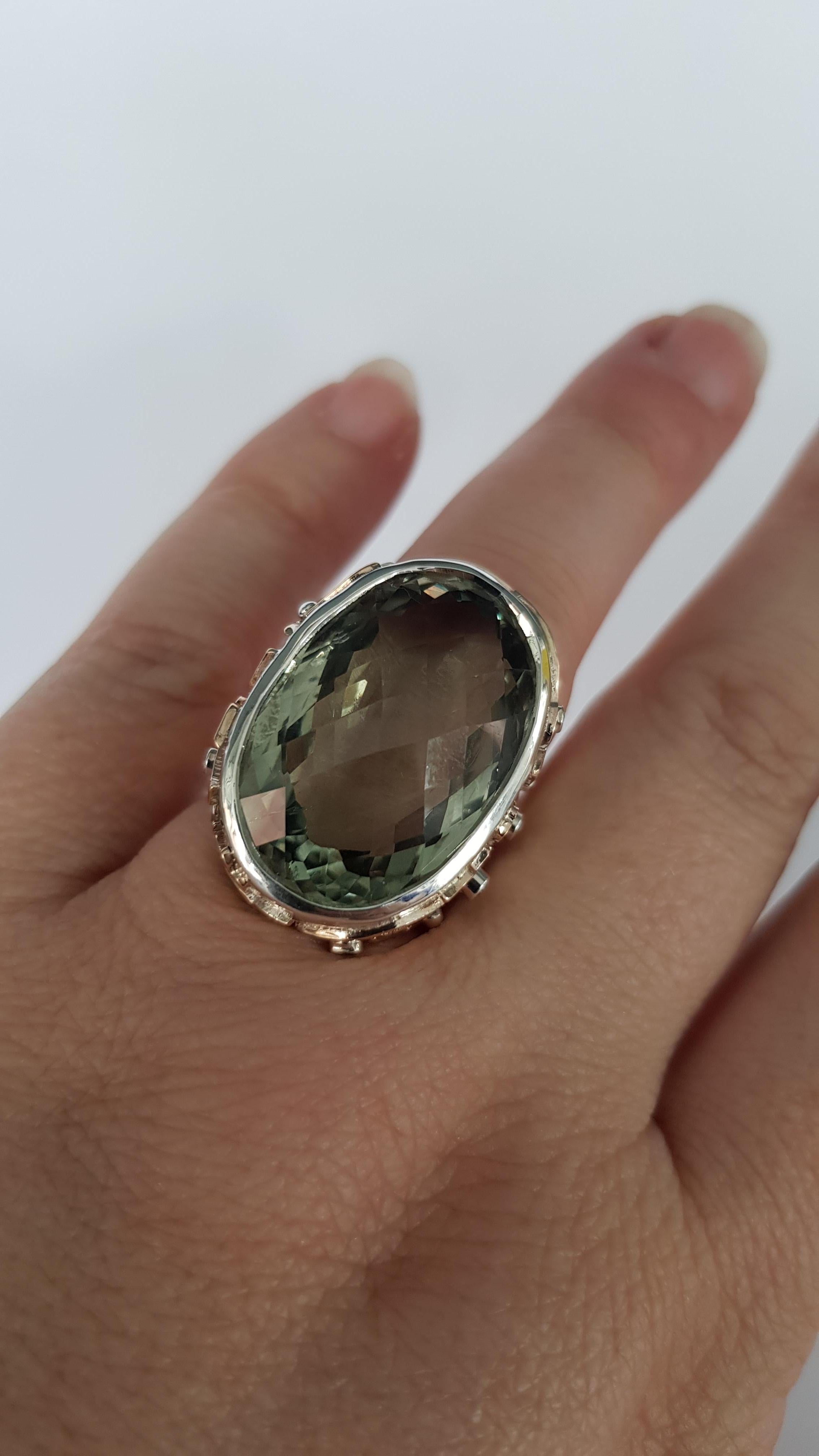 30cts of Prasolite and Diamond ring in silver and gold, it has lovely detail all over the ring not really caught in the picture here,  this is a large and beautiful dress ring ,a real flash of sultry green

ring size o
limited resizing 
