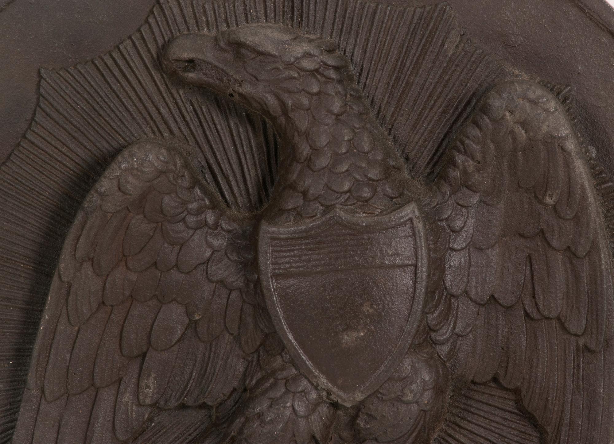 AMERICAN, PRE-CIVIL WAR, CAST IRON MEDALLION / PLAQUE WITH A FEDERAL EAGLE SUPERIMPOSED ON A SUNBURST, DATED 1857

Cast iron medallion / plaque of generous scale, approximately 18