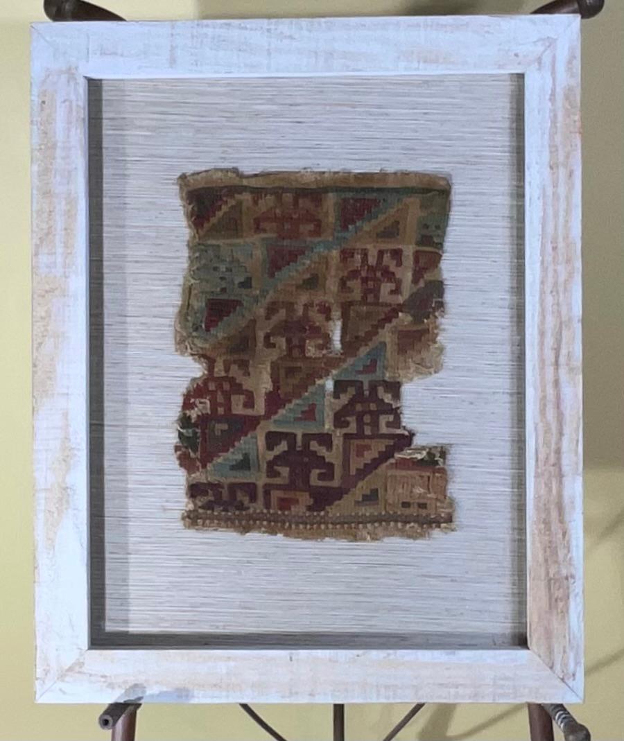 Museum quality handwoven textile fragment, featuring human , or Martian motif professionally mounted on cotton matte , in very decorative wood frame as shadows box . The textile dated from late horizon -early colonial AD 1476 to 1600 slit