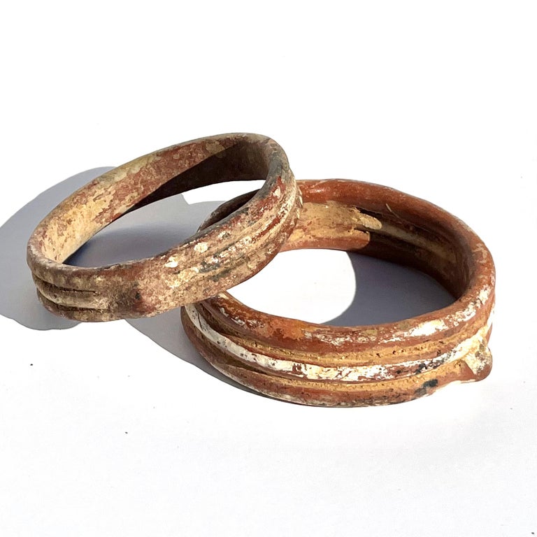 Pre Colombian, West Mexico, Michoacán Protoclassic Period Circa 500- 100 BCE

A fine and usable near pair of pottery bracelets each formed from 3 equally sized rings of clay layer horizontally and boasting pigments or burnt sienna, black, beige