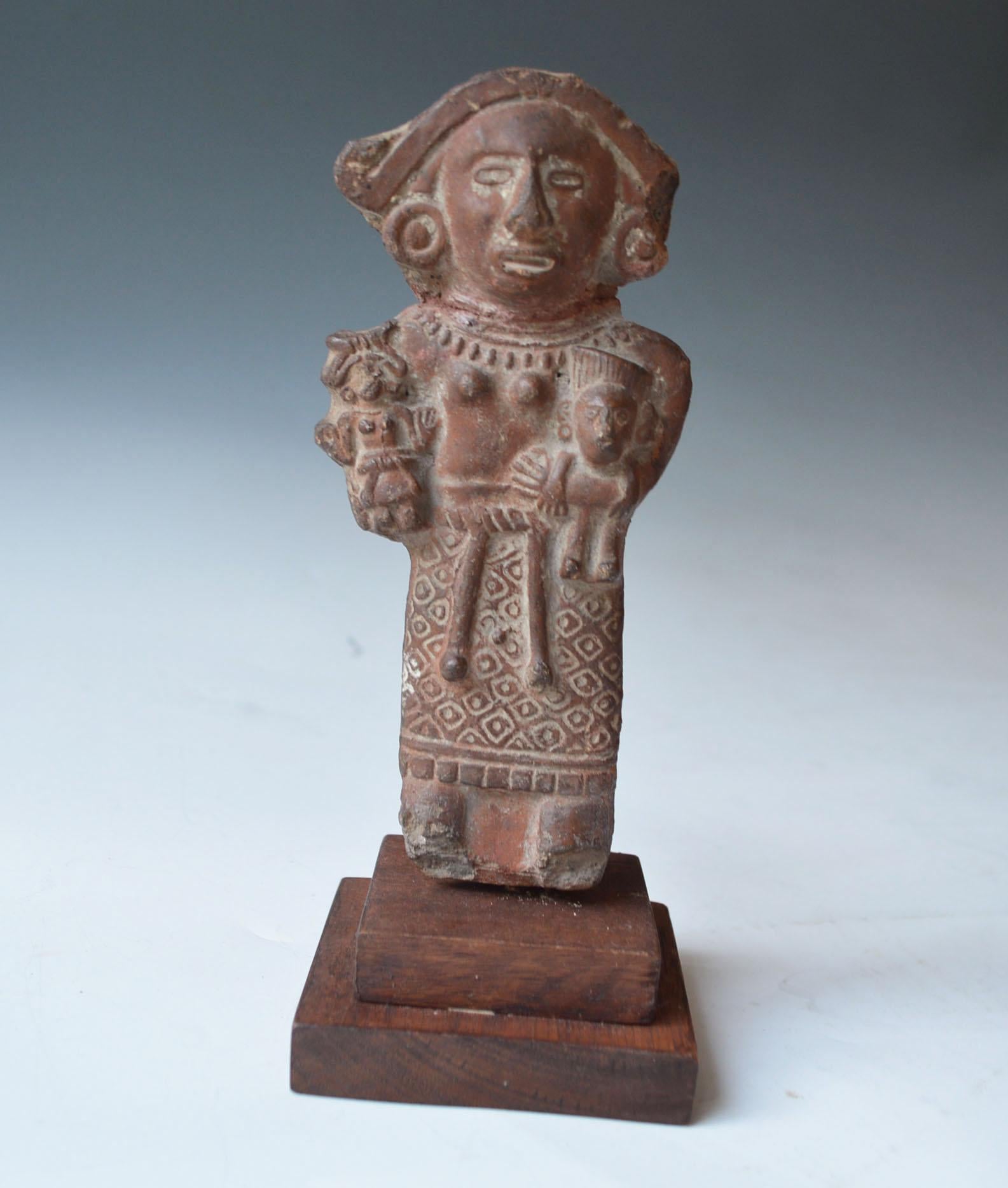 Pre Columbian Aztec Rattle figure Cihuacóatl Aztec CA. A.D. 1300-1521

A rattle figure in the form of the fertility goddess Cihuacoatl
The female figure with finely modeled design standing with open mouthed holding two children

Old Collection