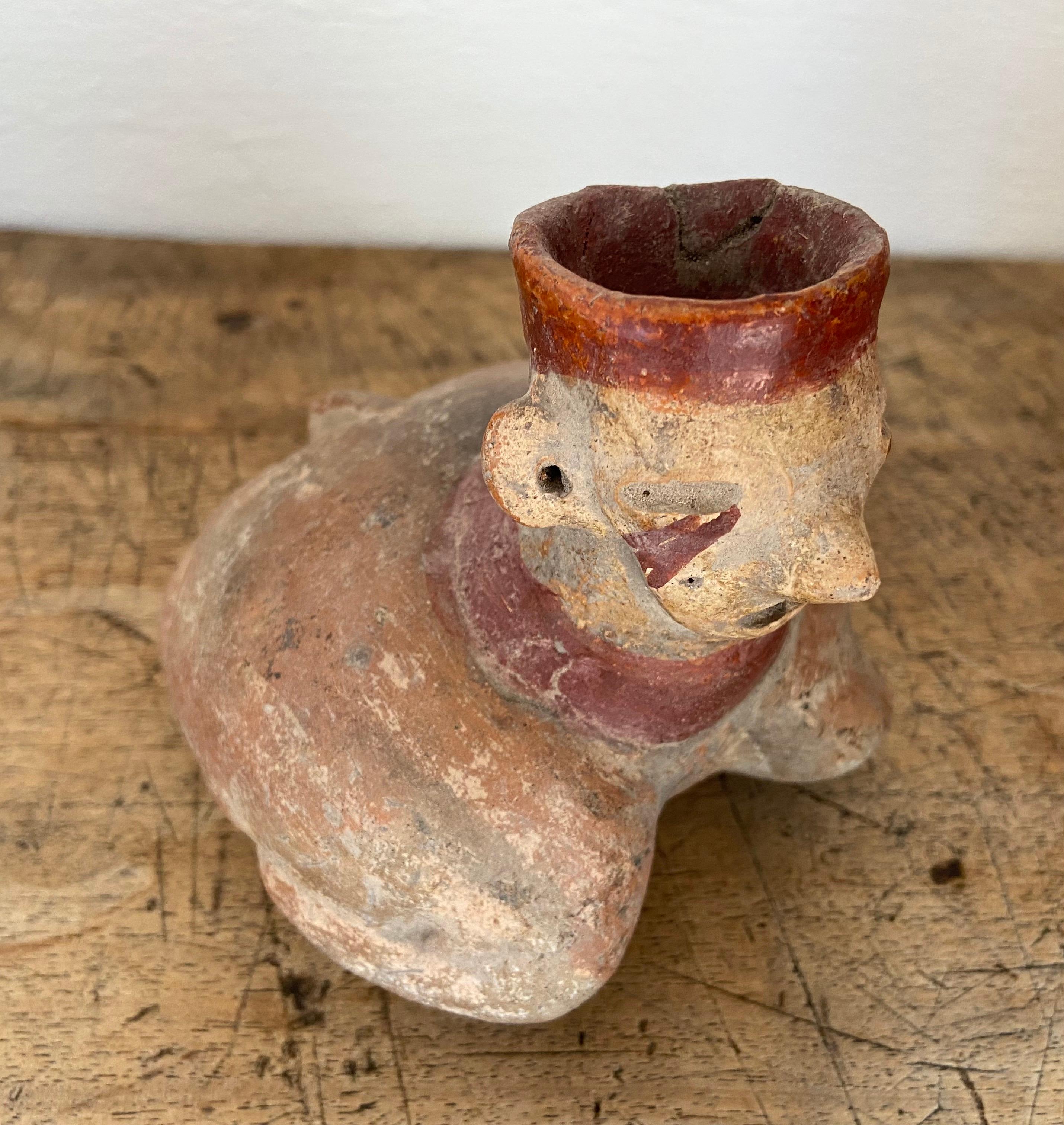 Prehispanic turtle vessel with human head and red paint, from the outskirts of Ixtlan del Rio, Nayarit, Mexico, date unknown. Appears to be a candleholder or copal burner. Rim on the head has been chipped at one point and glued.