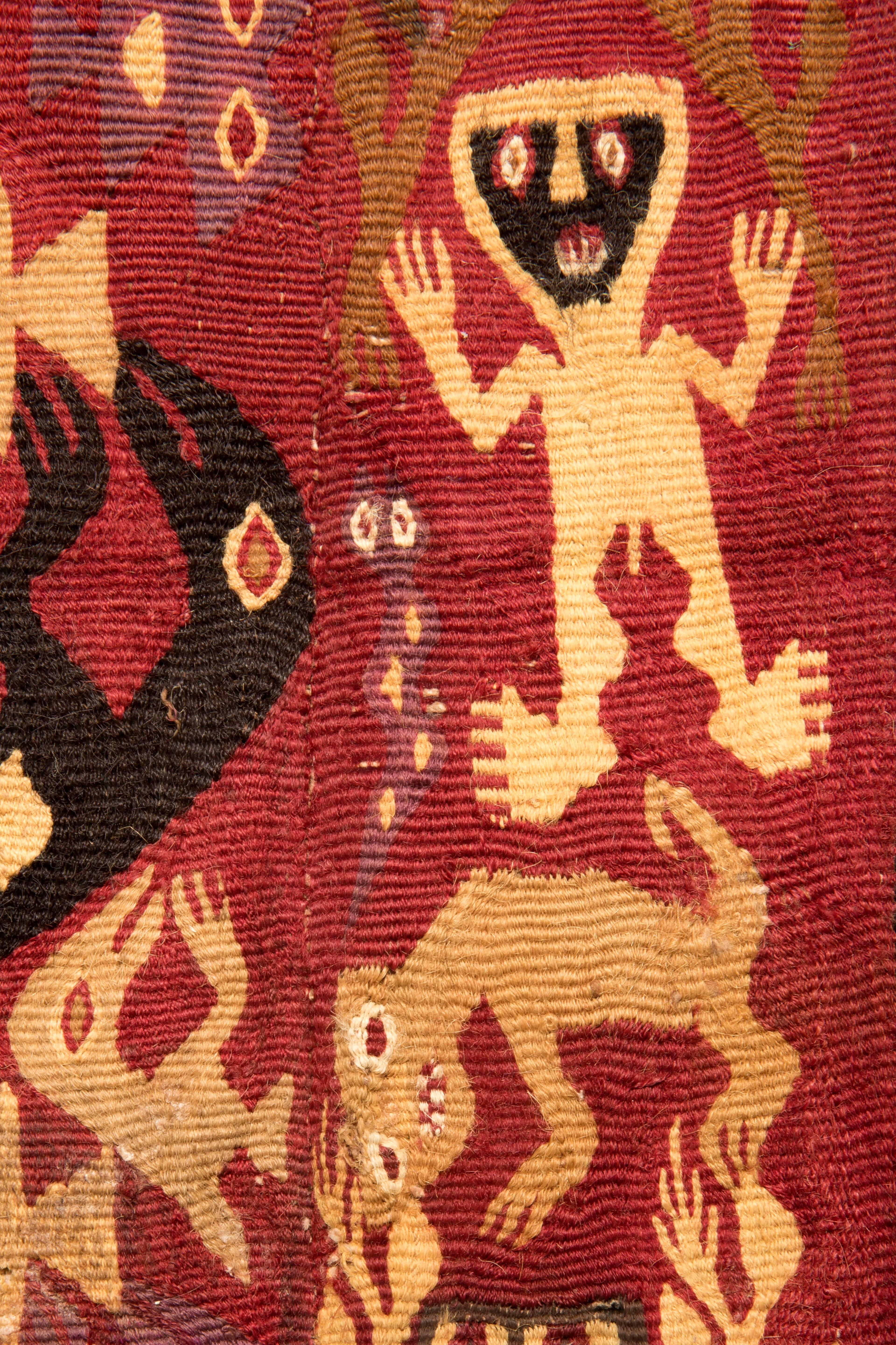 Brown Chancay coca bag with shamans and zoomorphic figures depicted in the centre on a in various colors on a red background.

This piece is accompanied by an EU cultural goods certificate.