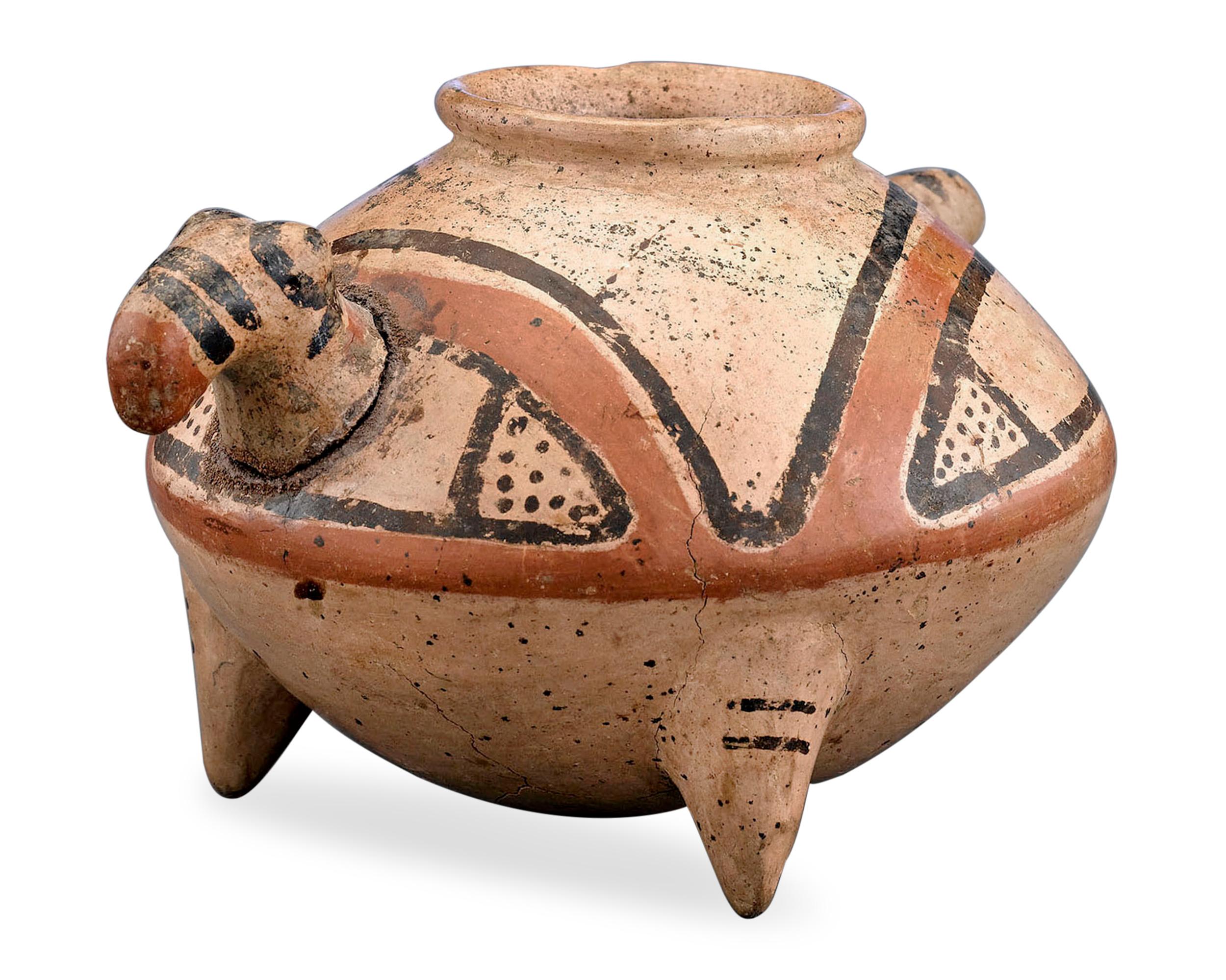 This rare Pre-Columbian vessel from the ancient Diquís culture of present-day Costa Rica possesses the features of a bird. The three-pegged jar was a common type of burial vessel, meaning it once would have been used during important funerary