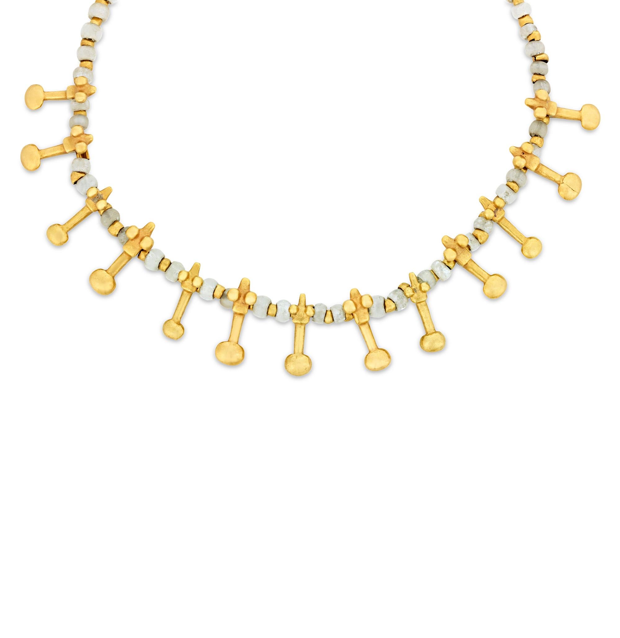 This gold and bead necklace, was crafted by a pre-Columbian artisan from the Gran Coclé area of Panama. It represents a rich cultural tradition of adornment, utilizing some of the most advanced gold-casting techniques known to the world at that