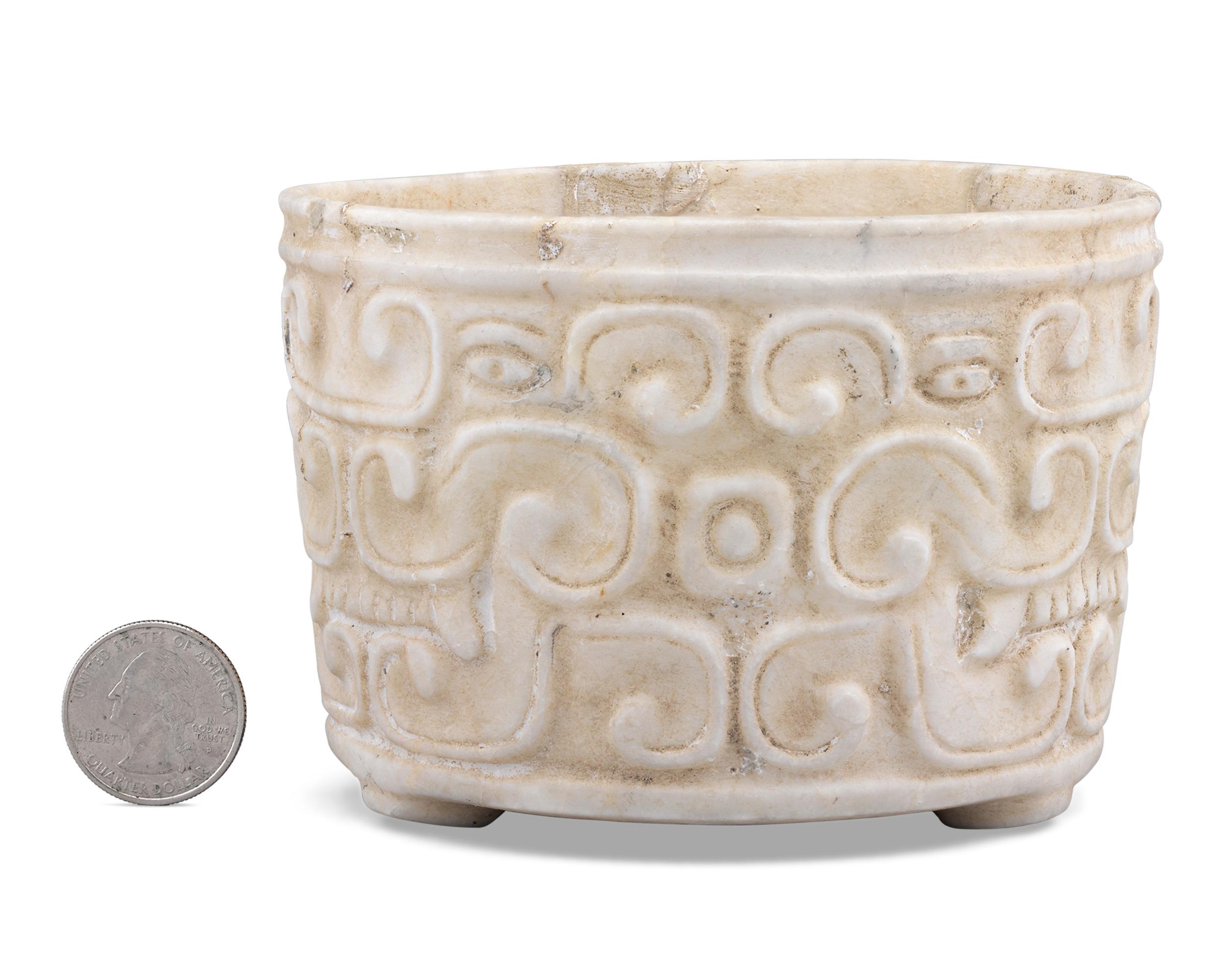 This exceptionally rare Ulúa marble bowl displays the lustrous white glow of the stone vessels that are native to the Ulúa river valley region of Honduras. With its alluring fluid flow of relief carvings around the entirety of its form, it