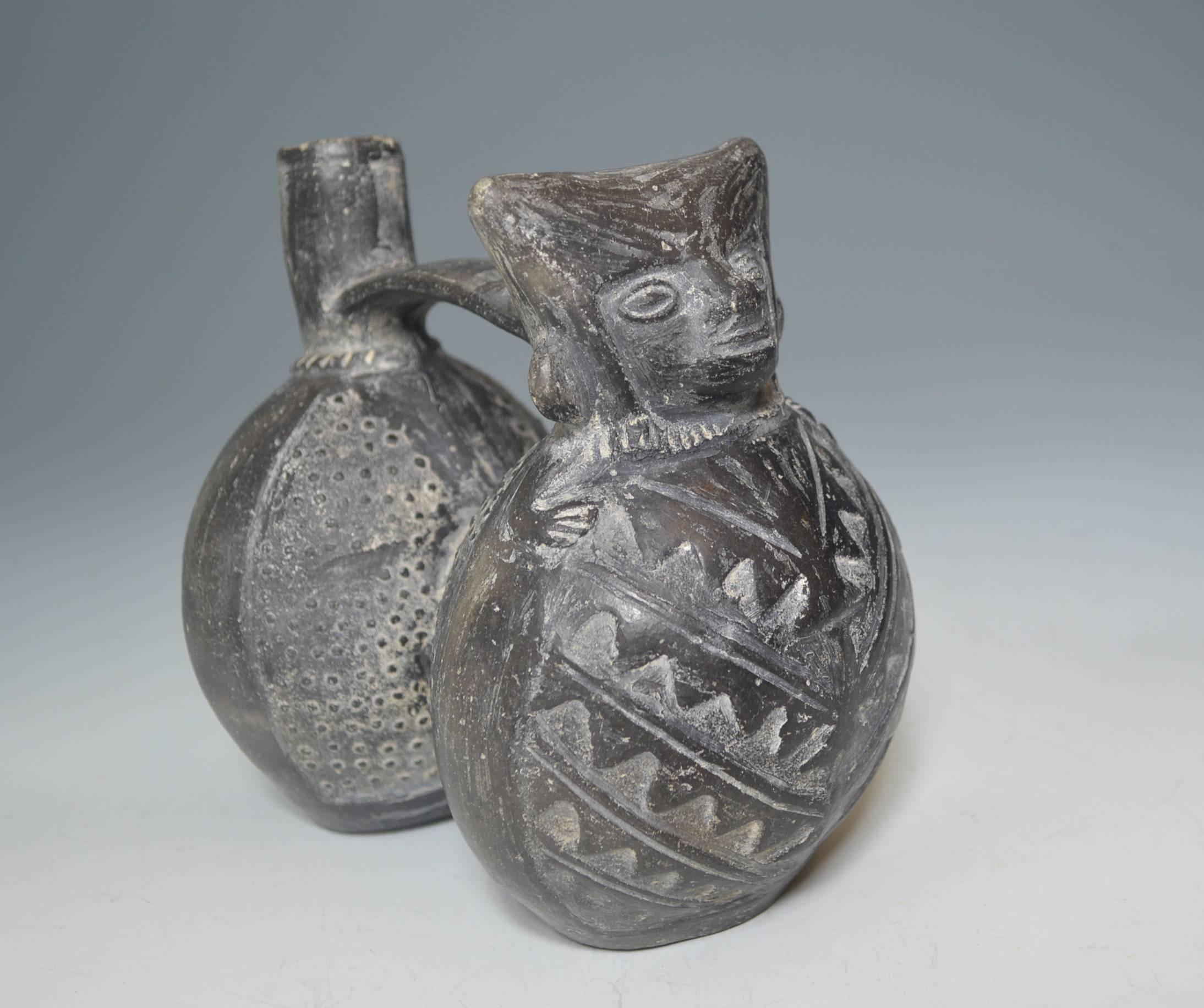 Pre Columbian Inca double chambered whistle vessel, circa 1438-1532, Peru.
A fine double chambered whistle vessel featuring a personage with a v shaped
headpiece,
The figure with small arms over a geometric design poncho with Manta Ray design on