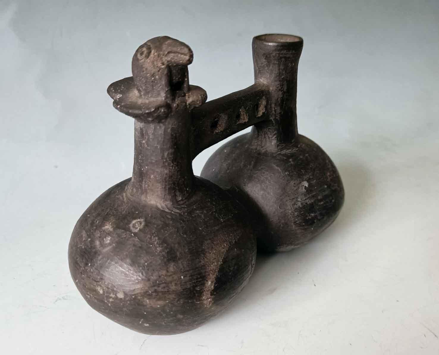 

 Pre Columbian Inca double chambered whistle Vessel Circa 15- 16th   Century Ad
A fine Inca greyware vessel double chambered with a bird whistle on the spout of one chambers.
These vessels produce a whistling sound when air is blown through and