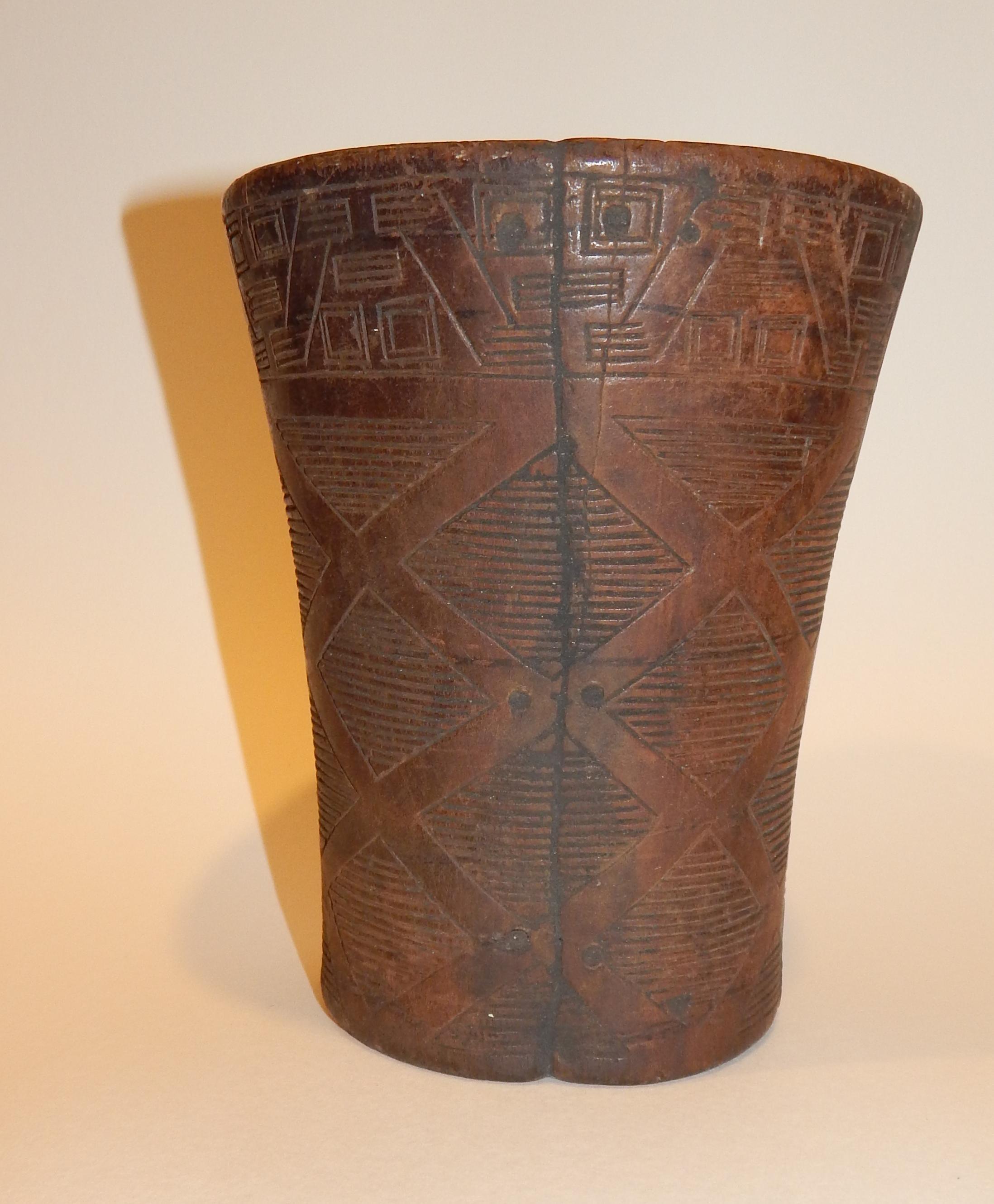 Large wooden Pre-Columbian Inca Kero cup.
From Central Peru, circa 1300 to 1500 AD. 
A hollowed wooden vessel, of conical form, decorated with carved incised lines in geometric pattern. 
Keros were traditionally made in pairs for the ritual