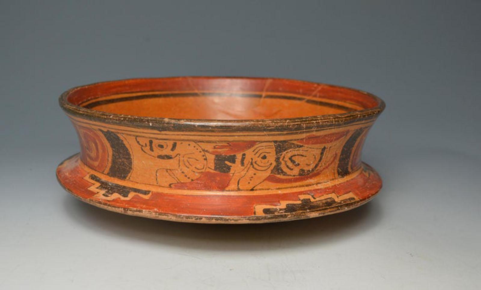 An impressive large Mayan Poly-chrome painted ceremonial pottery bowl
Guatemala/ central America late Classic period, circa A.D. 550-950,

A beautiful large bowl of tapering circular form with bifurcated sides on a tapering slanted base,
painted