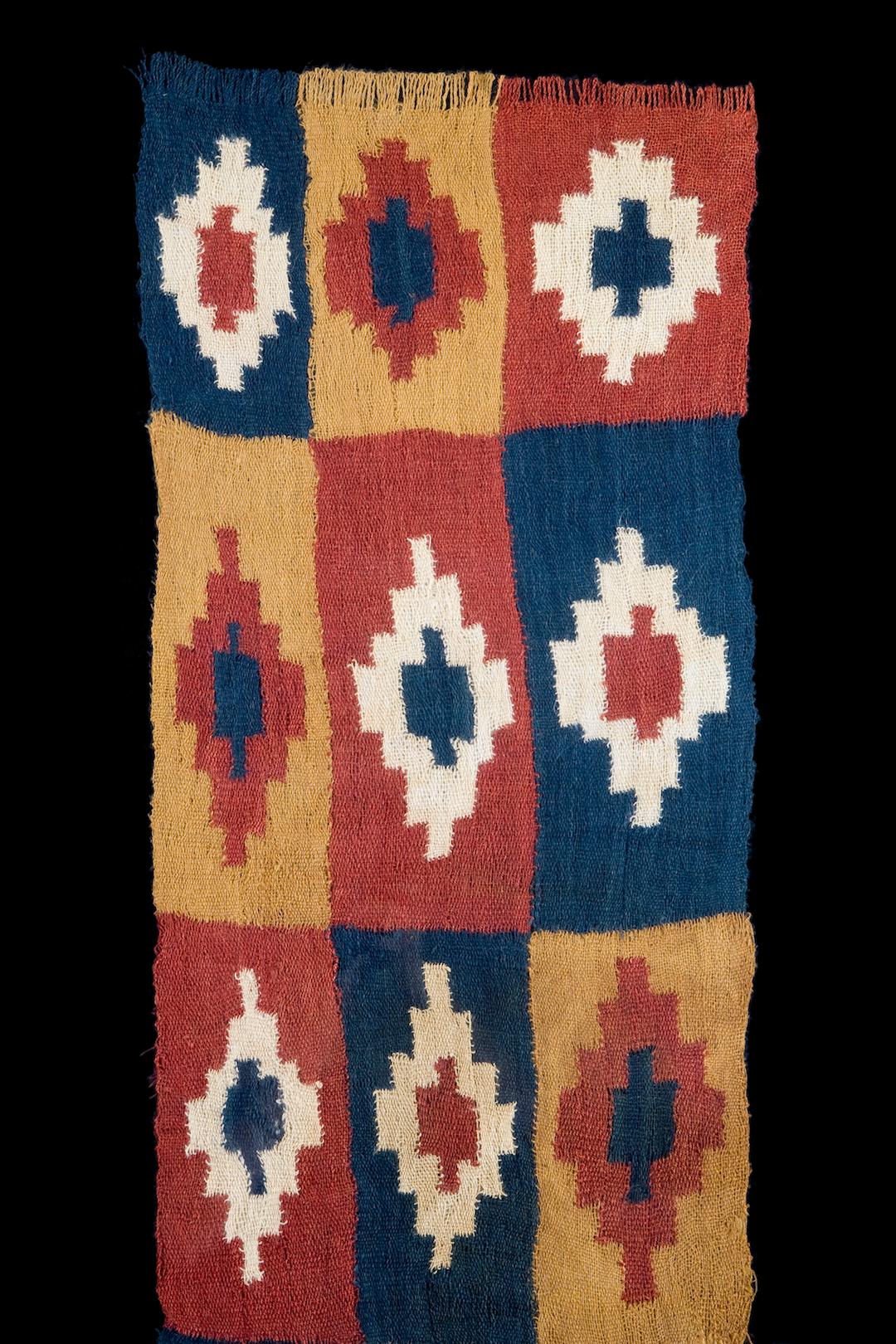 Complete Pre-Columbian Textile panel woven in plain weave with interlocking and alternating squares in bright shades, with elongated stepped diamonds, looped fringe on the short ends.

Nazca, Peru
300-600 AD

Ex-Sotheby's