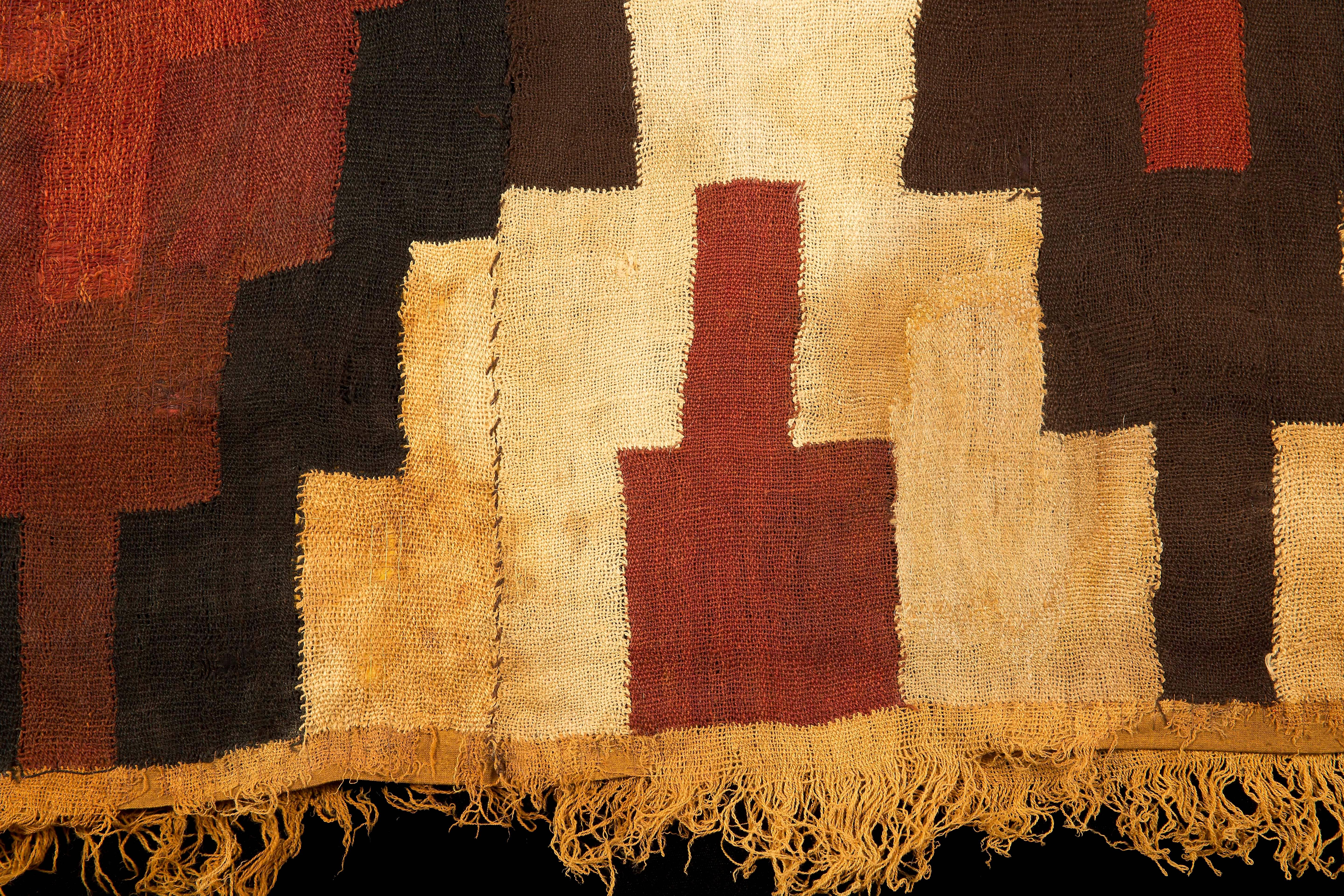 Nazca Tunic/Poncho of stepped design and fringe in yellow ocher, burgundy and brown. Perfect condition, museum quality.
