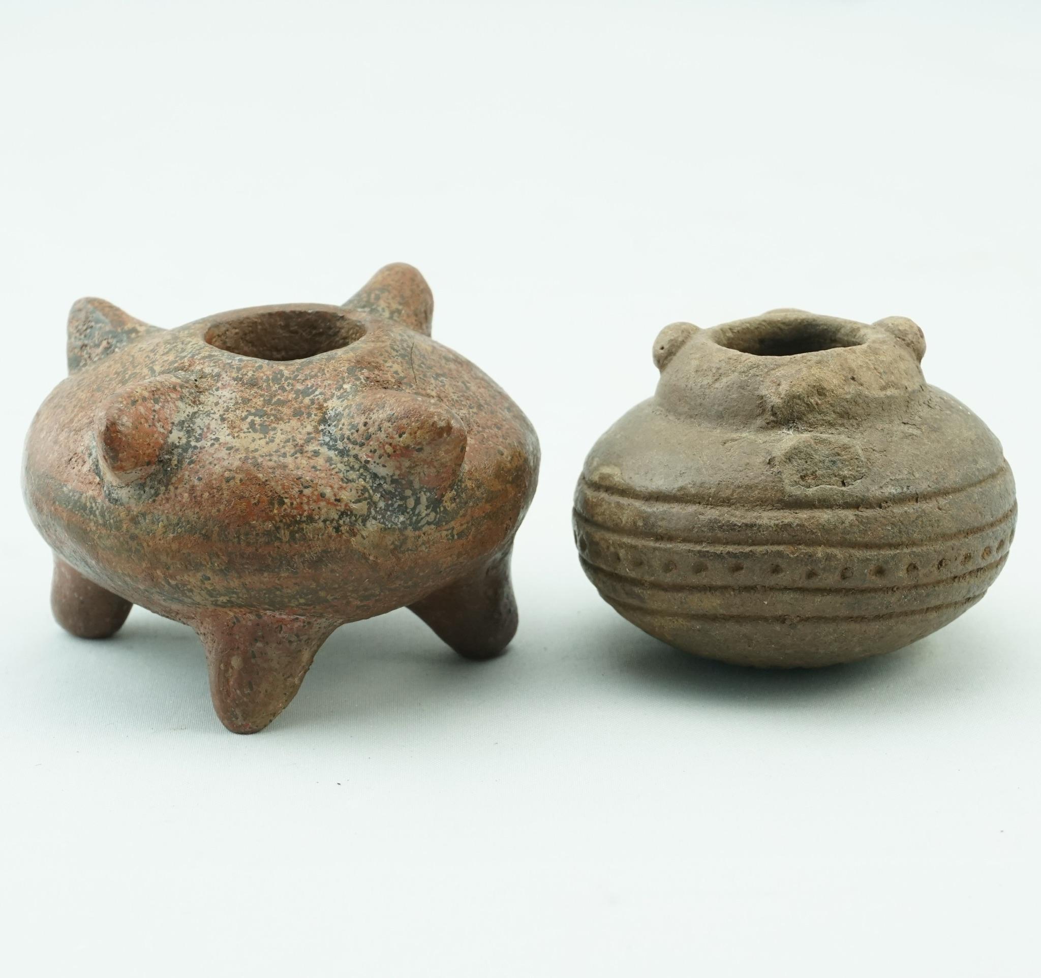Pair of diminutive Costa Rican pottery burial vessels. One tripod red and black polychromed zoomorphic vessel and a smaller decorated vessel. 100 AD -1350 AD 

Dimensions: 3 inches wide, 1.75 inches Tall 

Smaller: 2.4 inches Wide, 1.6 inches