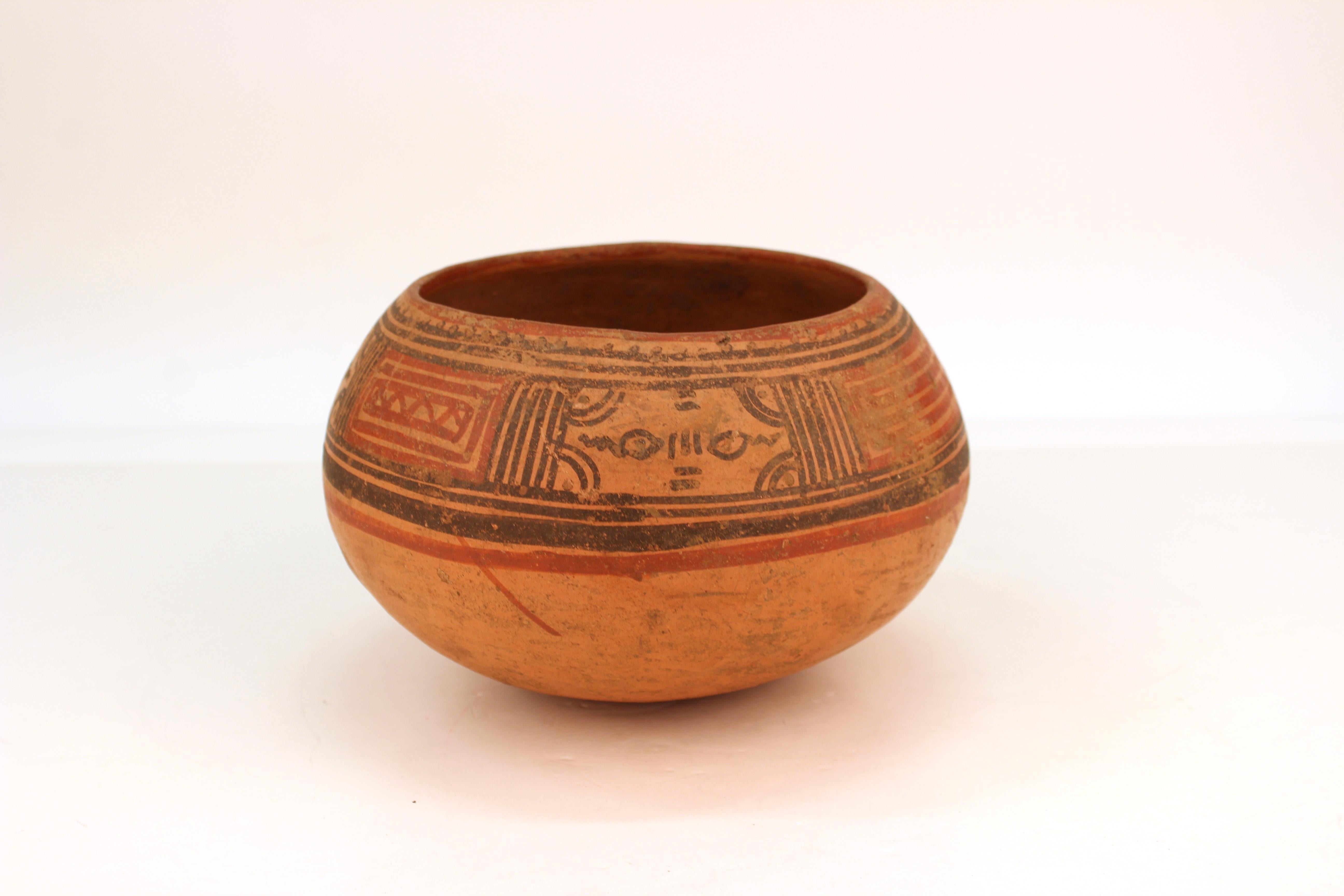 Pre-Columbian Nicoya pottery bowl from Costa Rica, Guanacaste Province, circa 800.
- 1200 CE. A round-bottomed red clay bowl painted with geometric designs and natural pigment decor in red and black. The piece has minor age- and use-related wear.