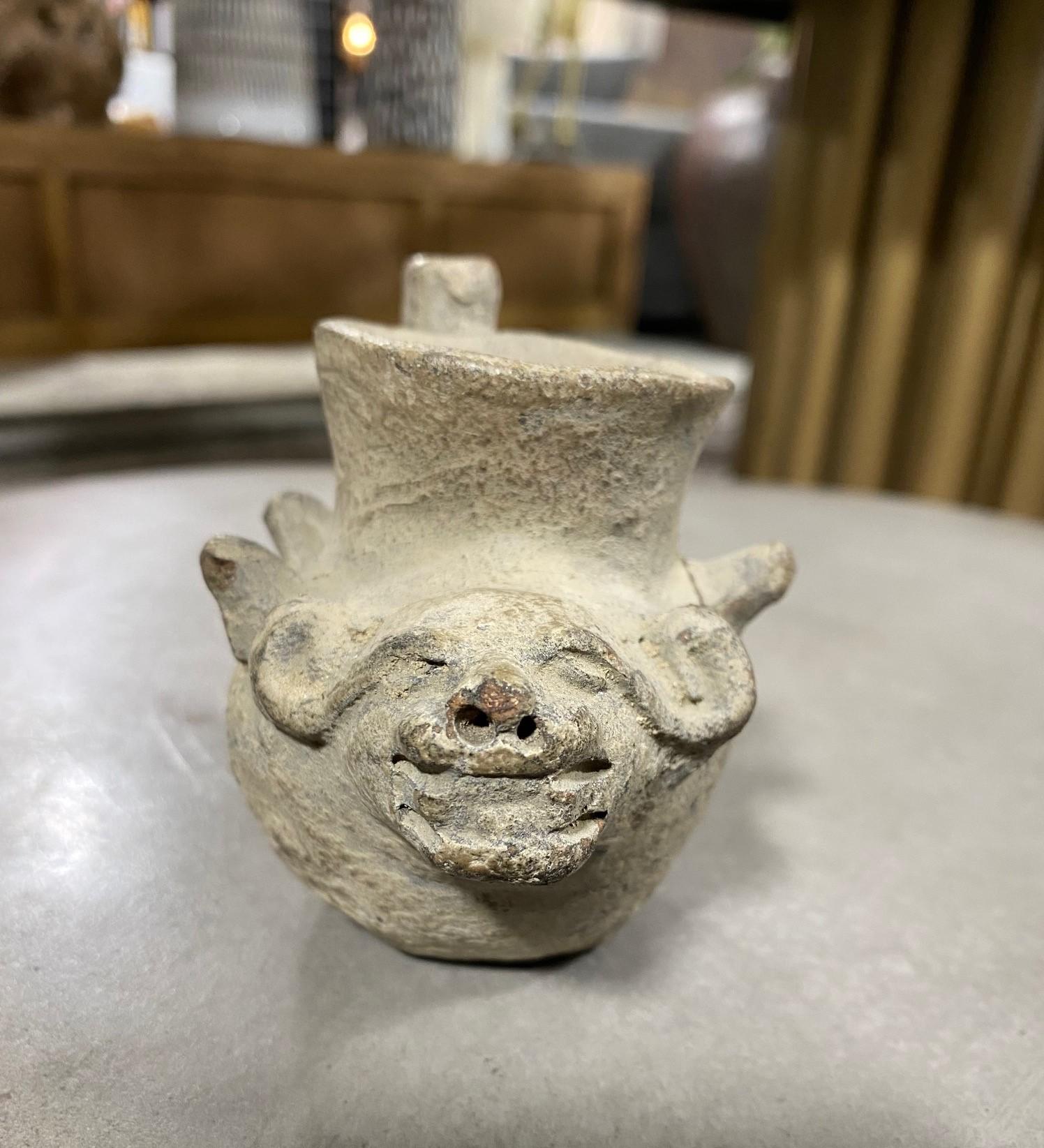 A wonderful Pre-Columbian spouted vessel with distinct features that of an ox or horned bull. 

Well crafted with a nice feel and look to it. From a collection of Primitive and tribal artifacts. 

Would be a nice addition to any Pre-Columbia or