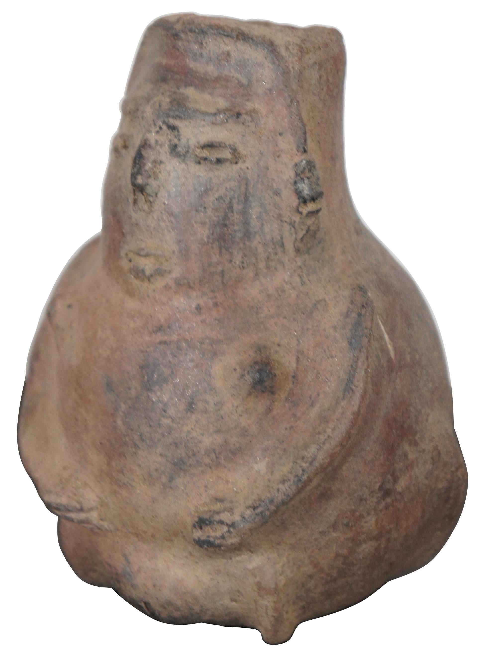 Antique Pre Columbian primitive earthenware Effigy bud vase or vessel in the shape of a female figure featuring pointed breasts and a distinctly feminine pubic mound. Measures: 6”.
 