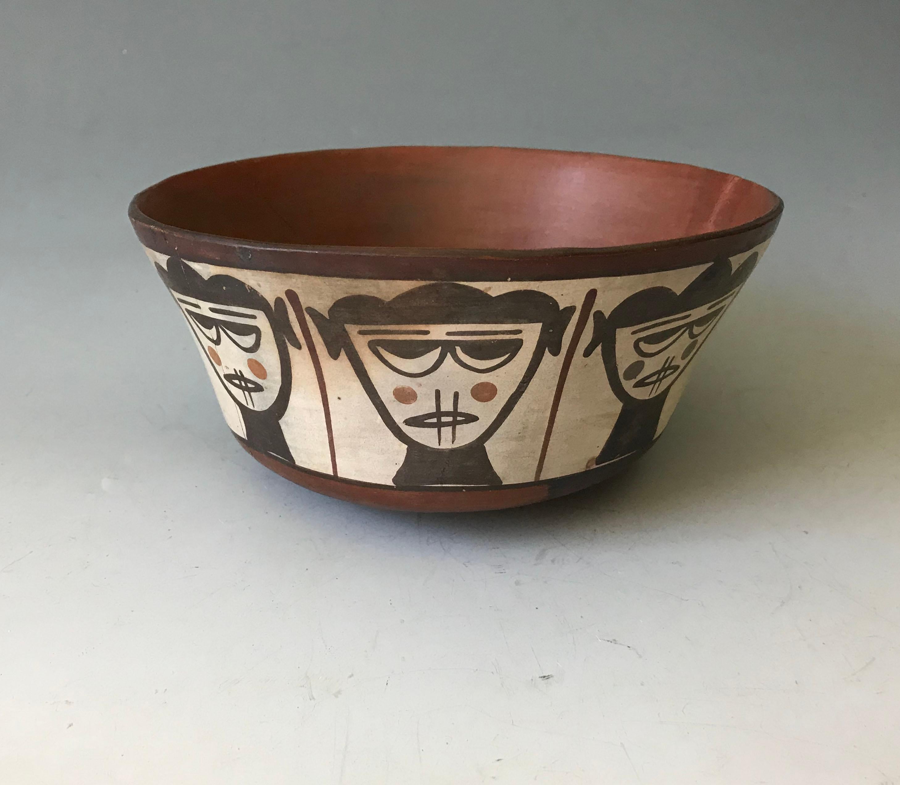 Rare Pre Columbian Nazca bowl with painted row of highly stylized female trophy heads with sewn mouths,
 
Size W 6 3/4 H 3 1/4 inches , 15.5 x 8 cm

Condition Cleanly joined from 3 large fragments with no restorations.

Ex Uk collection London Circa