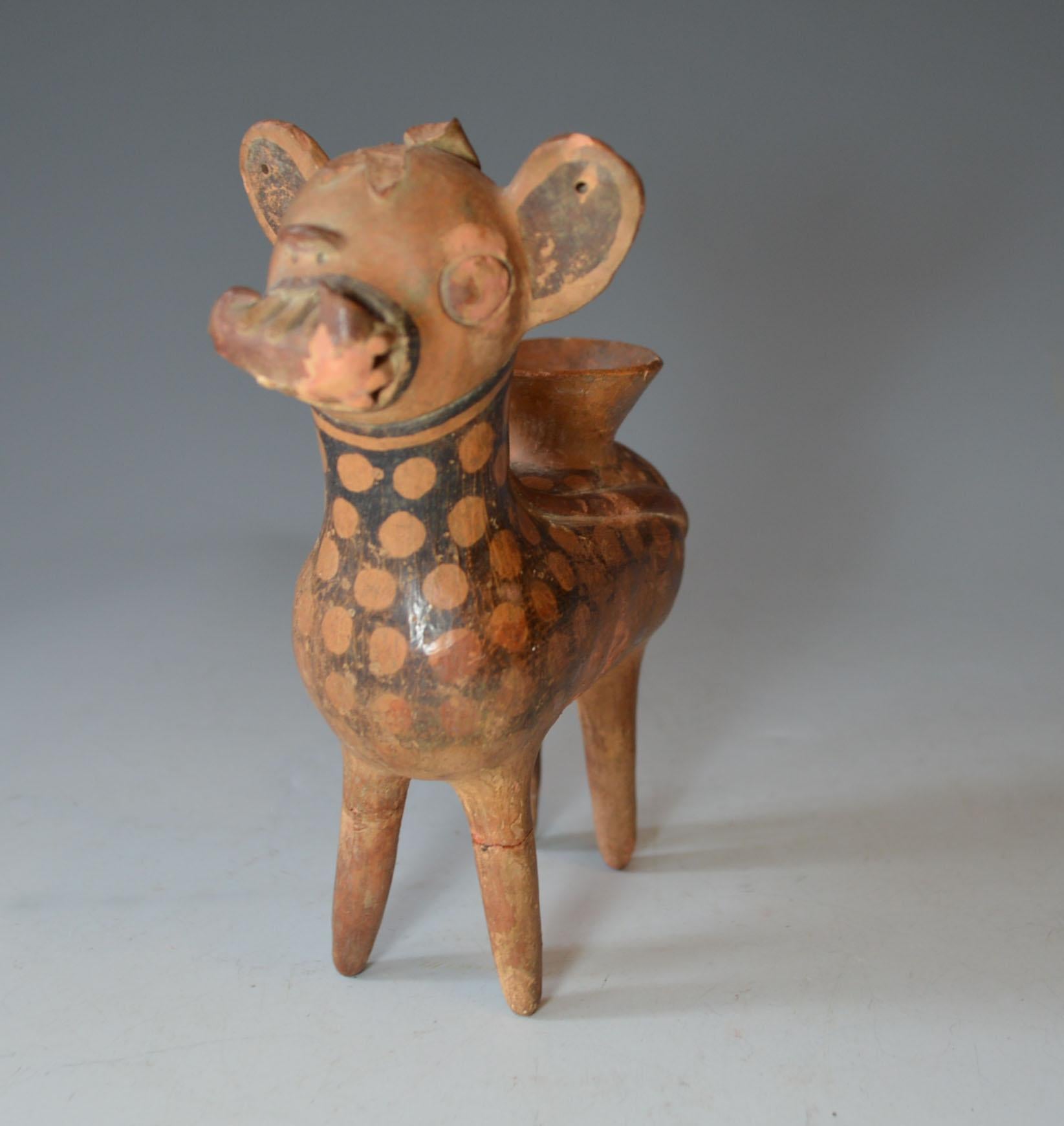 Pre Columbian art
A charming and very rare Recuay small spotted deer vessel, a very finely made vessel of a deer like creature with long tale and exaggerated teeth
hold and curved object in its mouth.
Pre-Columbian, northern highlands Peru, Recuay