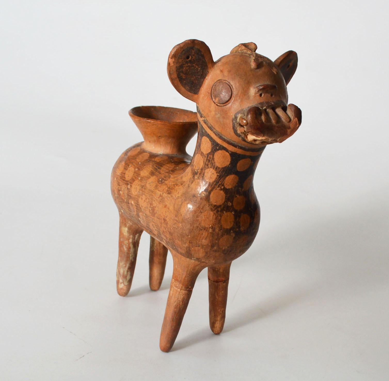 Pre Columbian rare recuay vessel Provenance Darwin Keynes.

A charming and very rare Museum quality Recuay vessel of a spotted deer , very finely crafted small spouted vessel of a deer with  long tale and exaggerated teeth, holding and curved