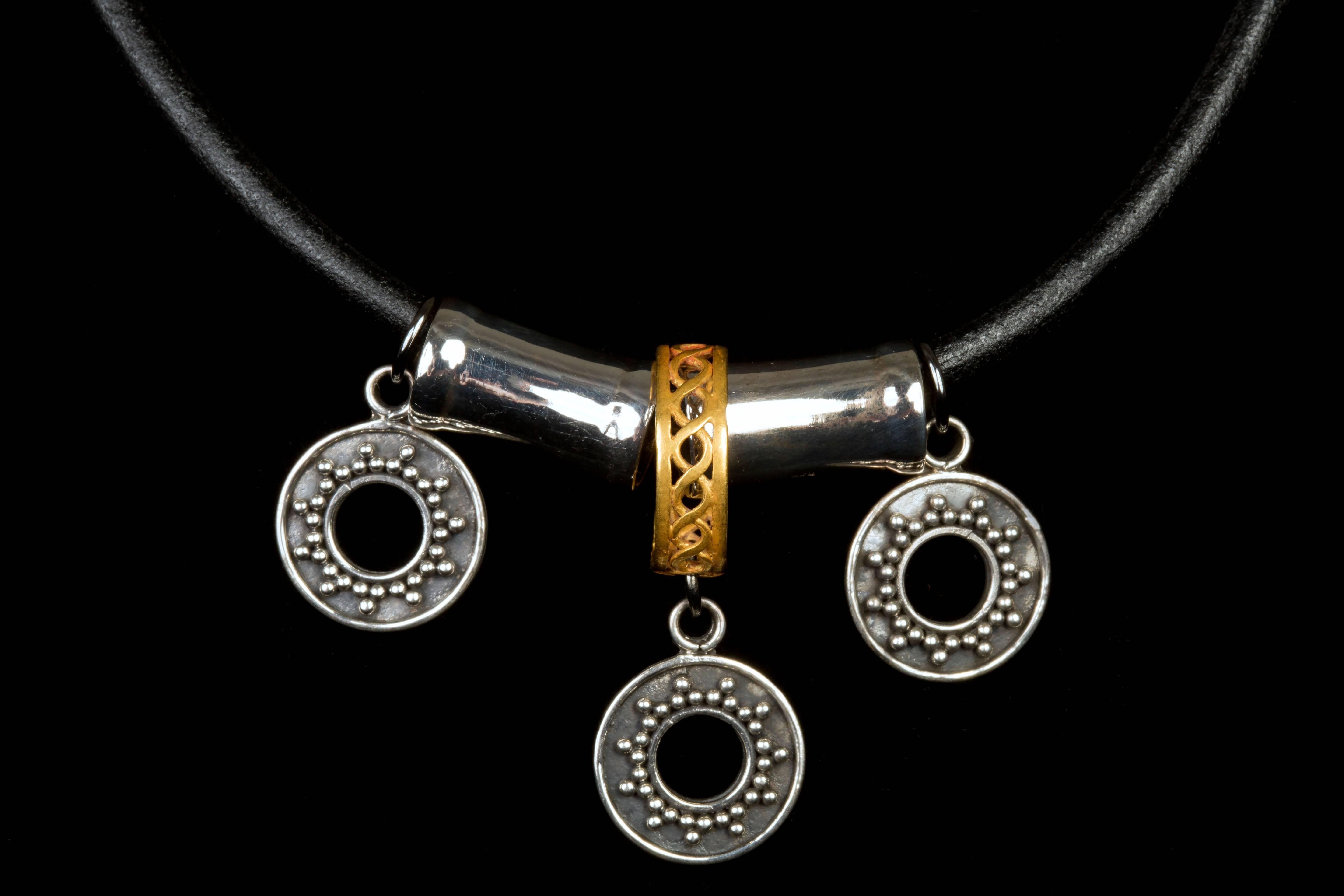 The central piece of this necklace was used as a ring in ancient times. Probably for a young individual given its size. It was made in the lost-wax technique with interlaced strands. Adorned with 3 contemporary roundels.

This piece comes from our