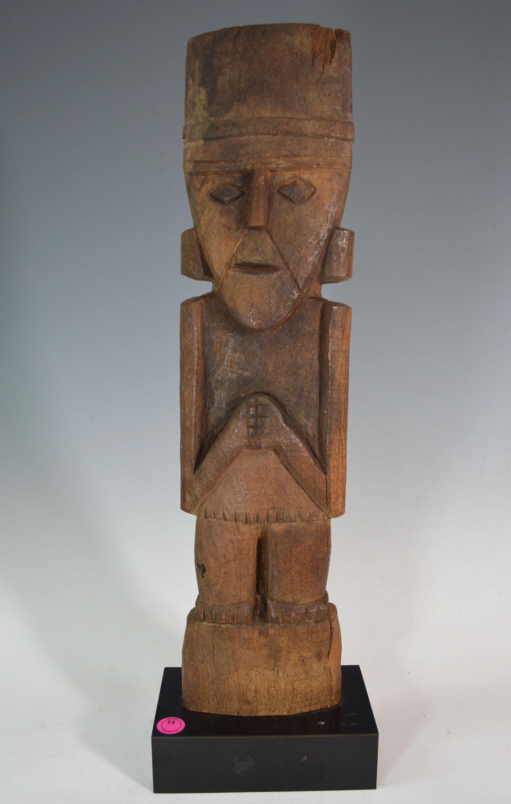 Pre Columbian stunning large Chimú wood marker figure, circa 1100-1470 AD, Peru.
A large impressive Chimu wood standing figure with enigmatic expression with hand held together in front, with Headband ear spools and
wearing a loincloth tied at the