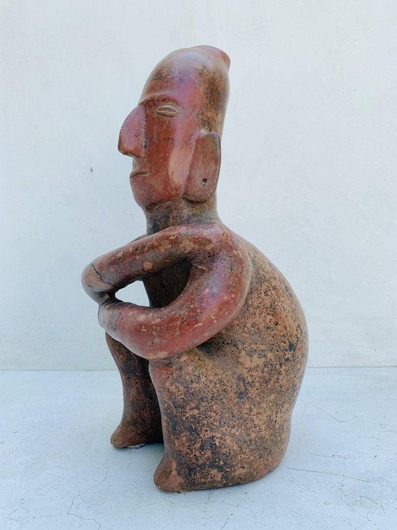Pre Columbian style clay sculpture of a man sitting down, in excellent condition.

Measurements:
15 inches high x 9 inches wide x 8 inches deep.