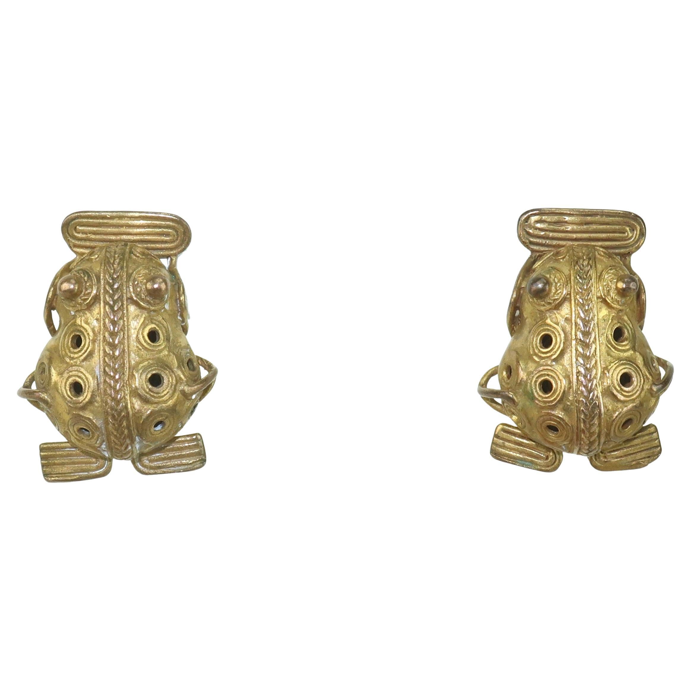 A blast from an ancient past!  Vintage Pre-Columbian style frog earrings with lever backed post hardware hallmarked 900 for coin silver and 10K for a gold vermeil wash.  The frogs are detailed with wire and both a braided and circular motif.  In