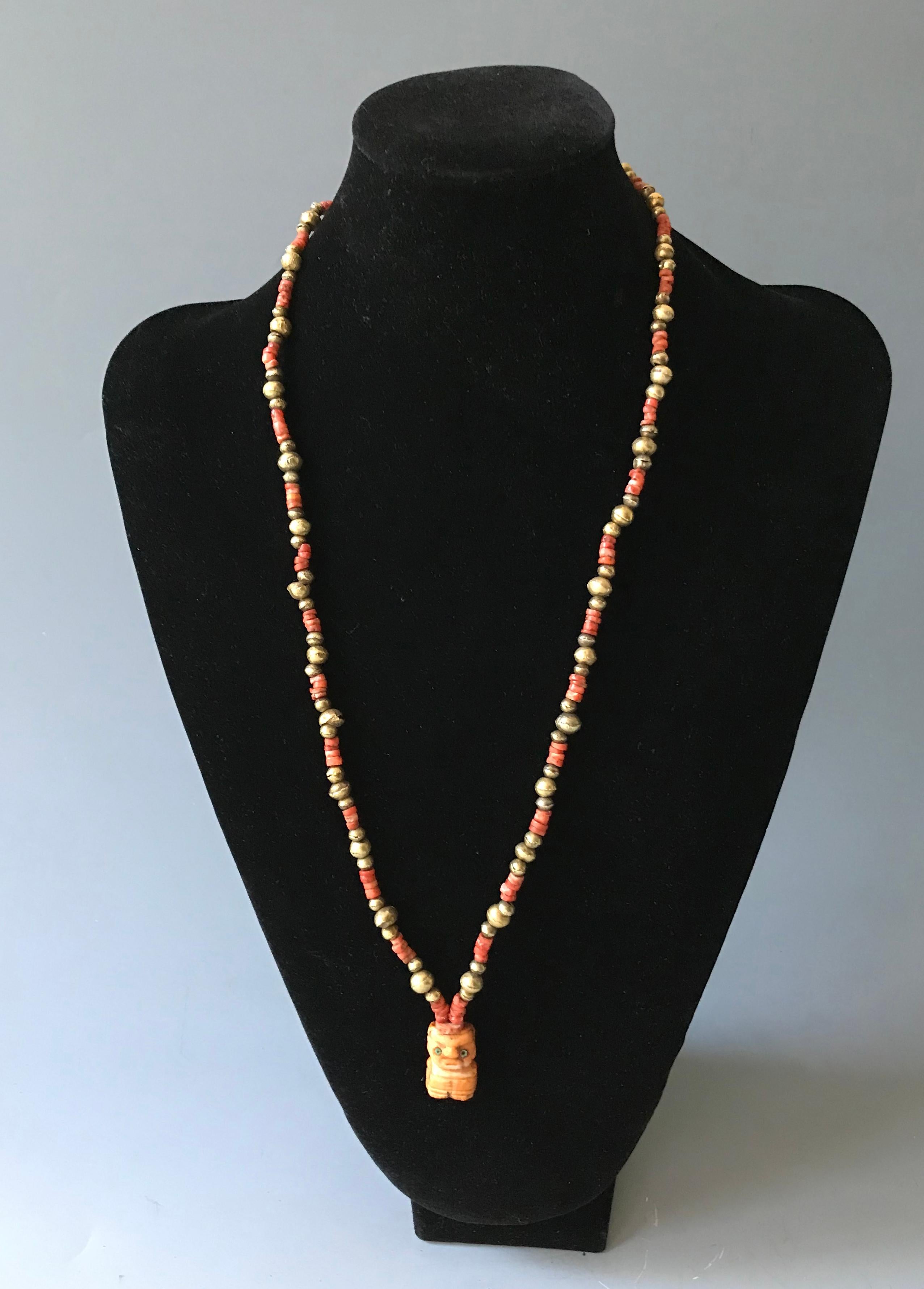 This wonderful Pre Columbian necklace features goldwork and Spondylus beads with carved figural pendant. ( Spoudylus is a type of Oyster commonly known as Spinly Sea Oster the shell resembling Coral is only found off the coast of northern Peru and