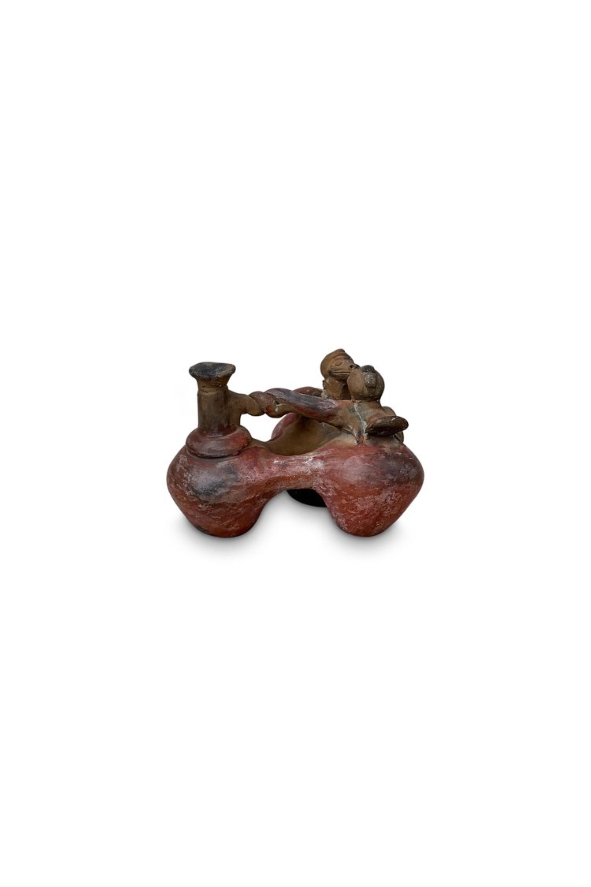 Pre-Columbian terracotta Chimu vessel pottery - explore the rich history of ancient artistry with this unique artifact as an enduring testament to the artistic value of the ancient Chimu civilization of Peru.

Measurements: 6” L x 7” W x 4.75”