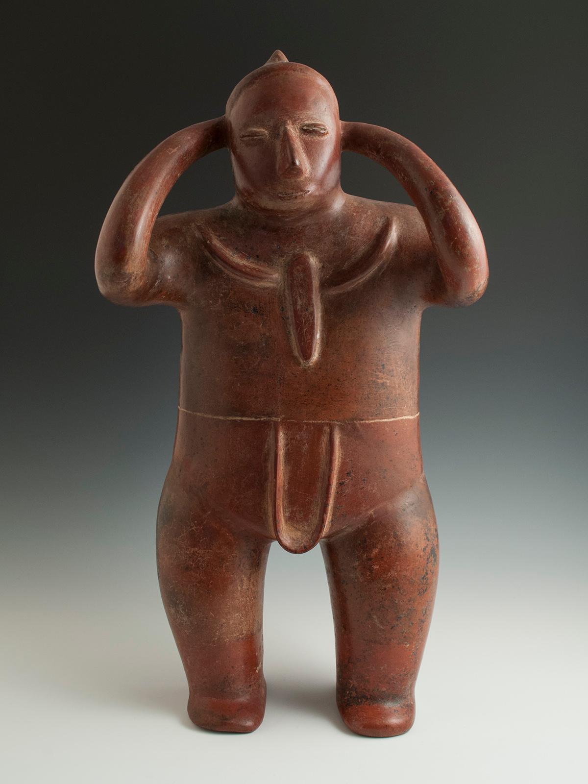 Pre-Columbian terracotta water carrier (Cargador) Colima, West Mexico
Protoclassic, 100 BC-AD 250

A large redware figure of a water carrier (cargador) with arms gracefully tapering and curving upward to adjust the tumpline on his forehead.