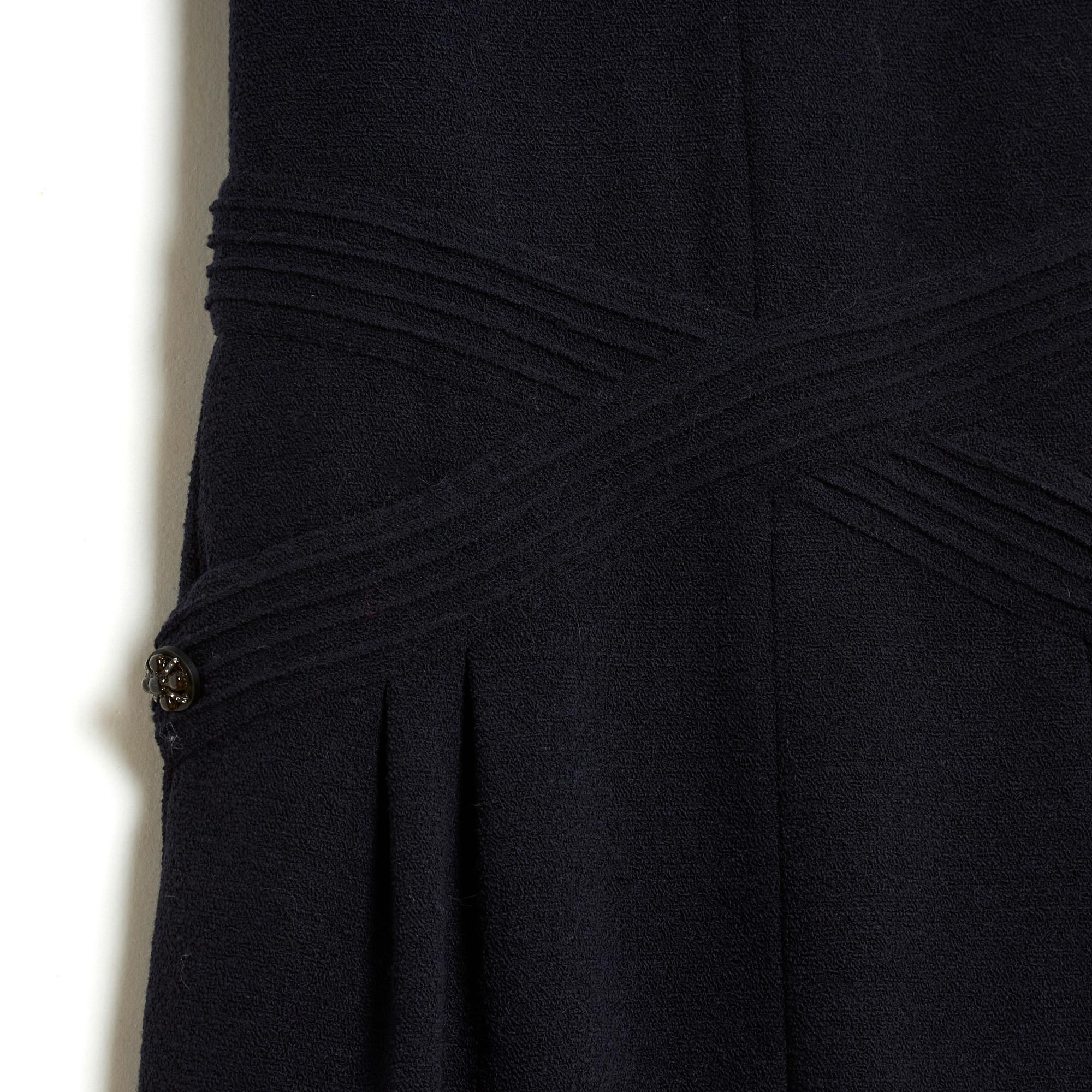 Chanel dress from the Métiers d'Art Paris Bombay collection (pre fall 2012) in navy blue terry wool, boat neck, crossed yoke on the top of the skirt concealing 2 slit pockets, slightly 