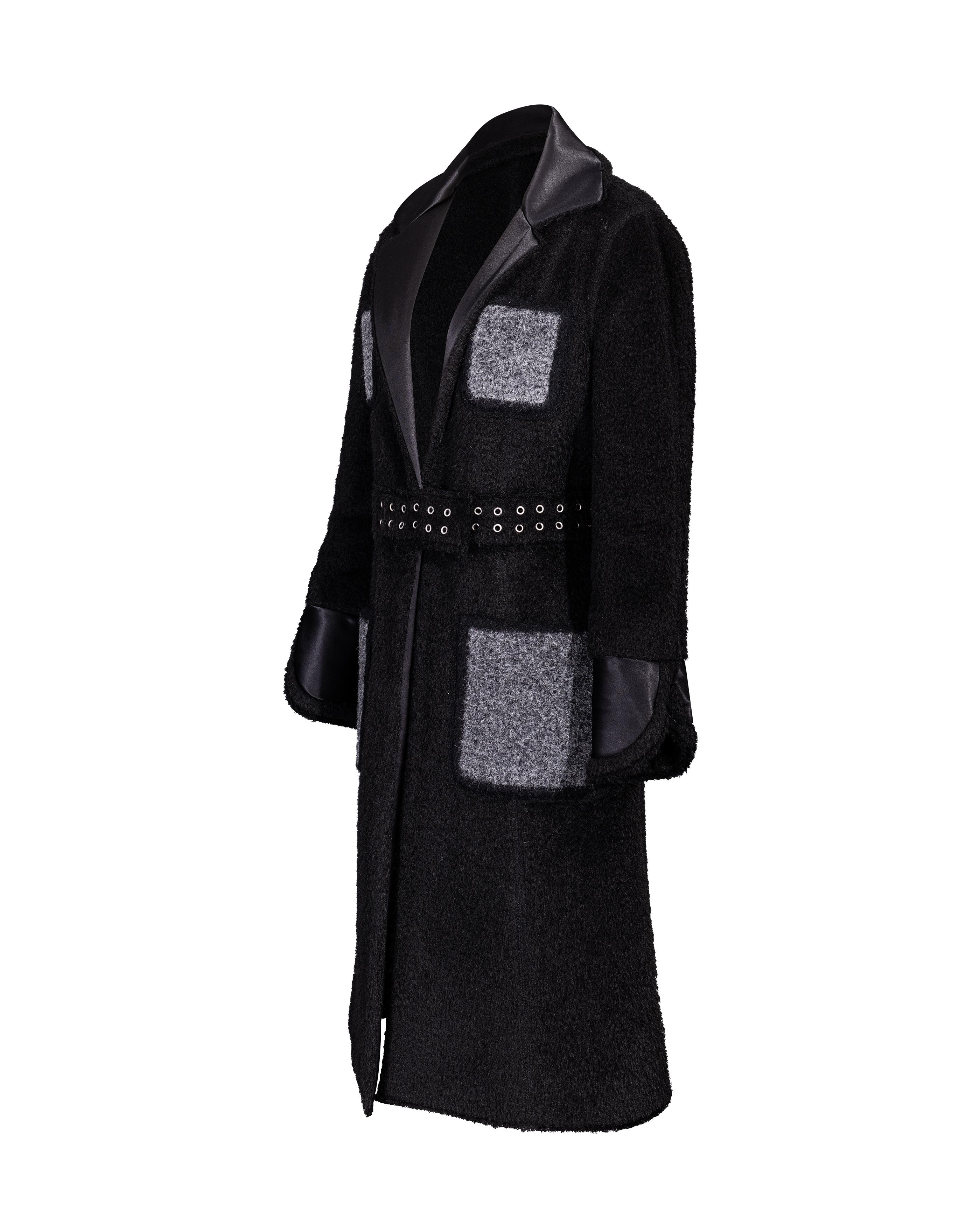 Pre-Fall 2014 Céline by Phoebe Philo black shearling coat with silk lapels and gray contrast pockets. Features built-in silver-tone grommet waist-belt with silver center buckle and snap closure. Silk contrast lapels and wrist details. Gray contrast