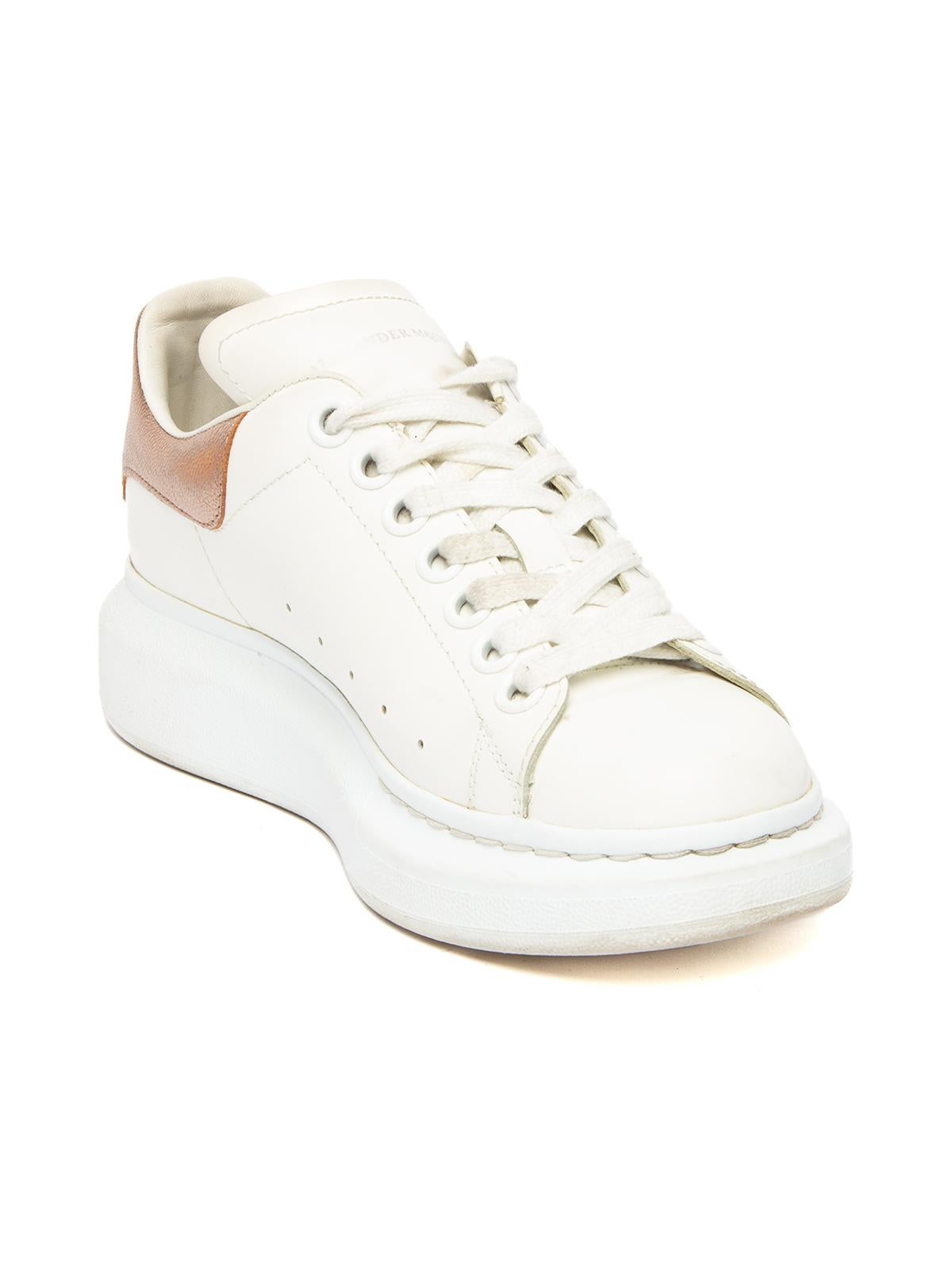 CONDITION is Good. Some wear to shoes is evident. Some wear to insoles, collar on sneakers, scuff marks to leather and slight wear to soles on this used Alexander McQueen designer resale item. Details White with rose gold collar Leather Low top