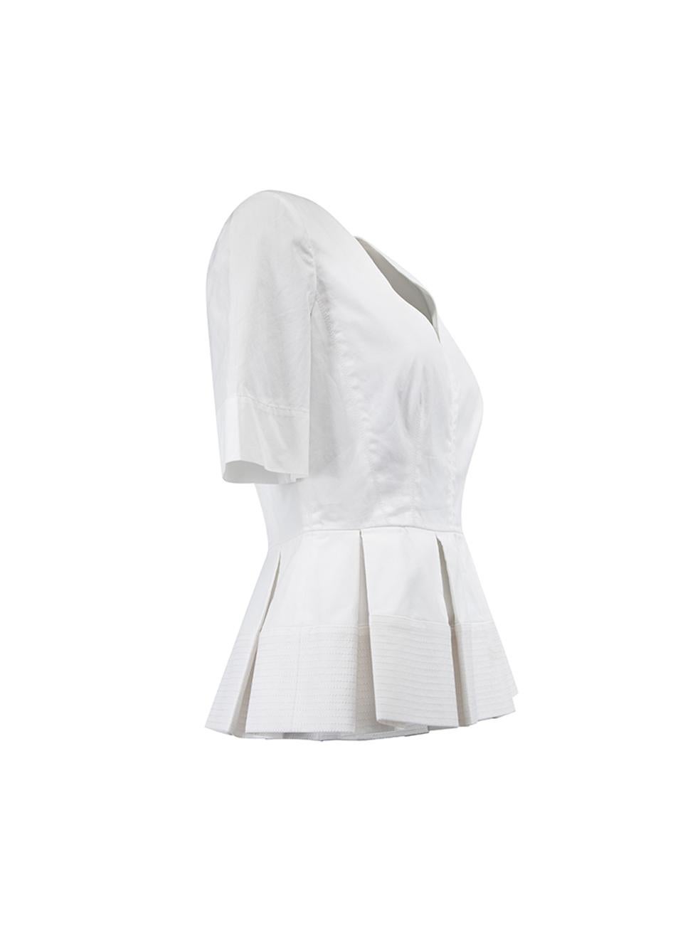 CONDITION is Very Good. Minor make up stain on the waist lining from try-on of top is evident on this used Balenciaga designer resale item. Details 2015 White Cotton Short sleeves top Pleated peplum hemline V neckline Back zip closure with hook and
