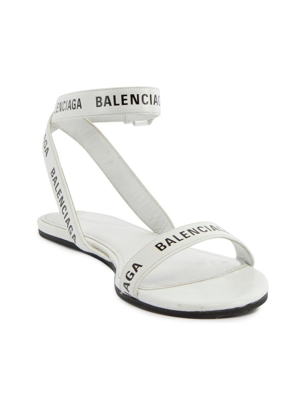 CONDITION is Very good. Minimal wear to sandals is evident. Indents and scratches can be seen on the back of heels of this used Balenciaga designer resale item. Details White Leather Sandals Flat heel Open toe Balenciaga logo straps Ankle strap