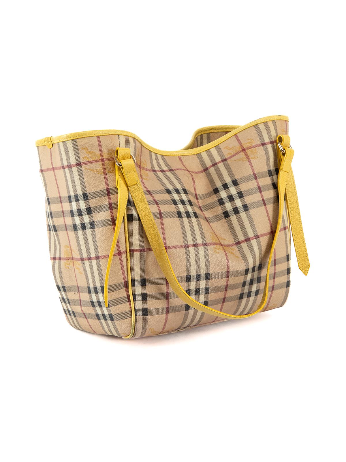 CONDITION is Very good. Minimal wear to bag is evident. Minimal wear to yellow leather handles and trim. The is also visible wear to the interior and the leather around the corners of bag on this used Burberry designer resale item. Details