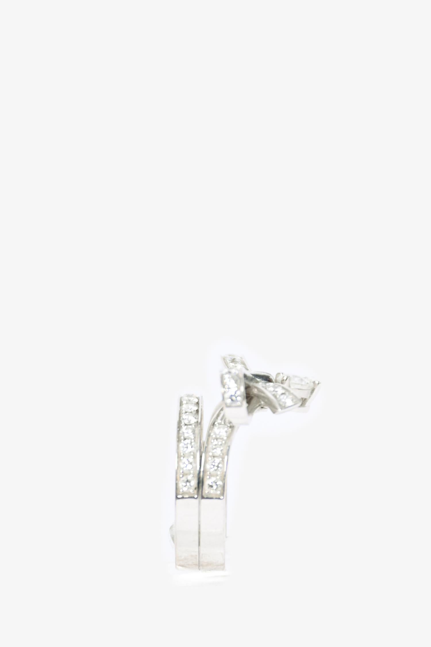 Chanel 18K White Gold Diamond Ruban Ring. 

Size: 6
Content: 18K White Gold. Diamonds. 
Condition: This item is in good pre-loved condition with wear on the band. All diamonds intact.
