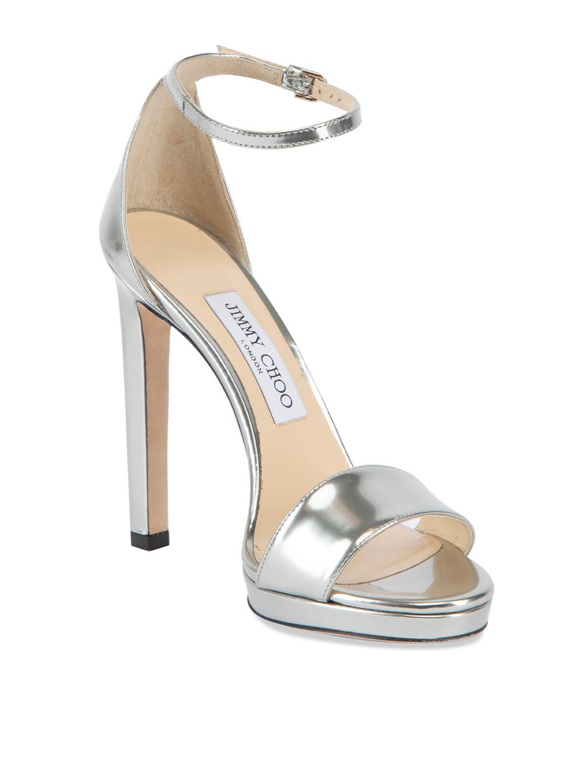 CONDITION Is Very good. Minimal wear to heels is evident. Minor markings on inner and outer soles on this used Jimmy Choo designer resale item. Details Silver Patent leather Sandal heels Slip on Peep almond toe High heel Buckled ankle strap Leather