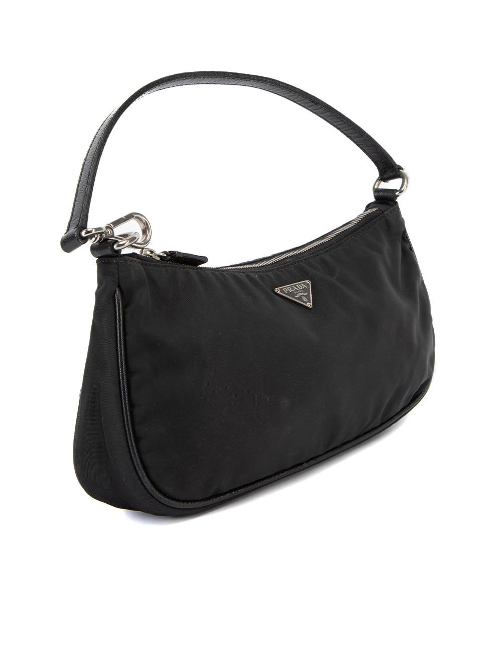 CONDITION is Very good. Minimal wear to bag is evident. Minor staining on the back of the bag, wear to leather strap and tarnish to zipper is seen on this used Prada designer resale item. Details Black Repurpose Nylon Mini shoulder bag Enamel