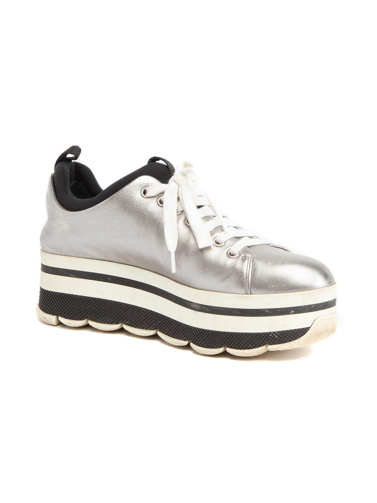 CONDITION is Very Good. Minimal wear to shoes is evident. Moderate signs of wear to midsole and slight scuffs around sneakers on this used Prada designer resale item. Details Silver Patent leather Lace up Flatform Round toe Made in Romania