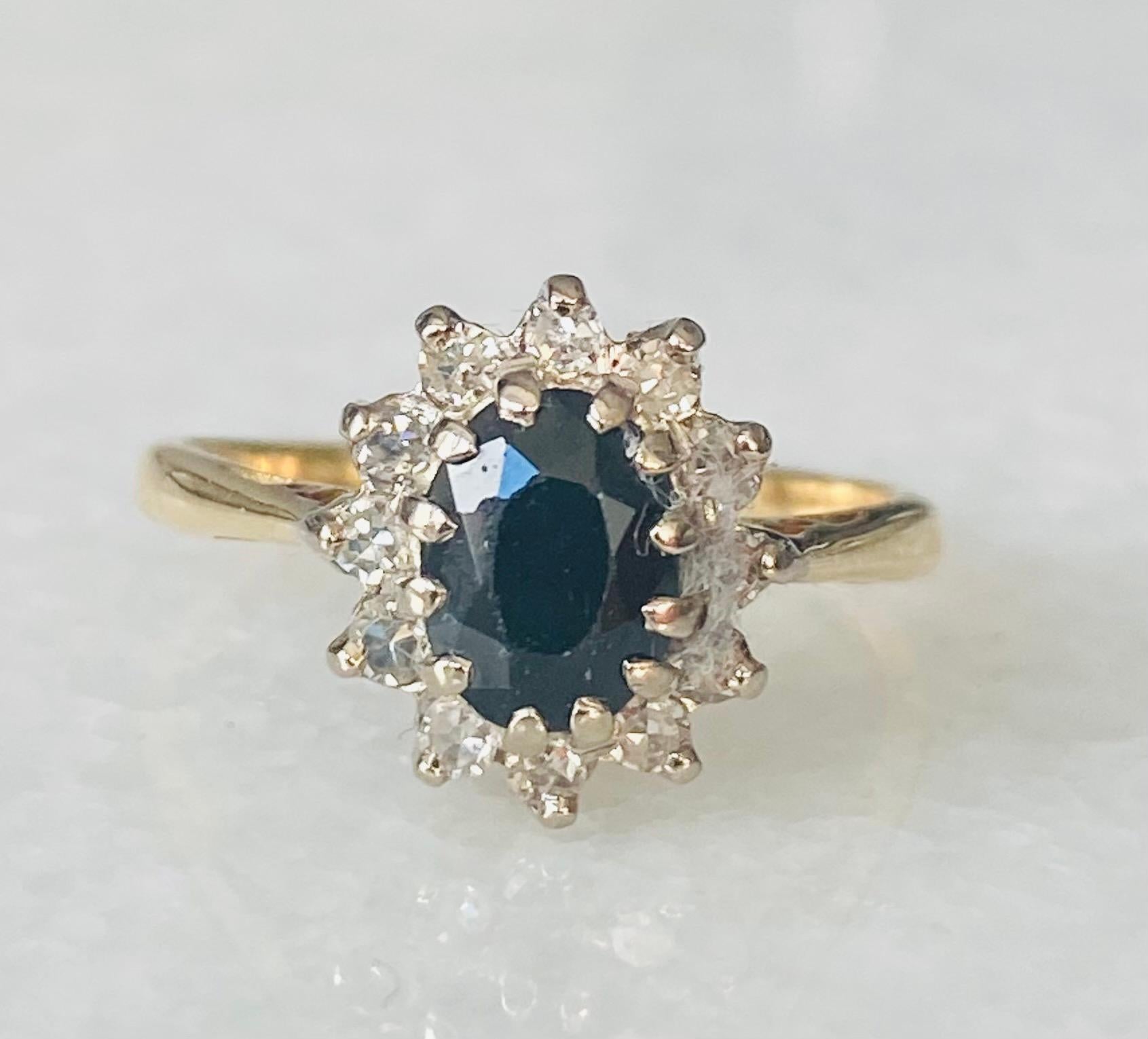 Fabulous 18 carat yellow golden vintage ring with blue sapphire surrounded with 12 brilliant cut diamonds. Each diamond is about 0.015 carat. The diamonds totally complete this ring. Ring size 6 3/4 (US) 17 1/4 (EU),  N 1/2 (UK) The sapphire of